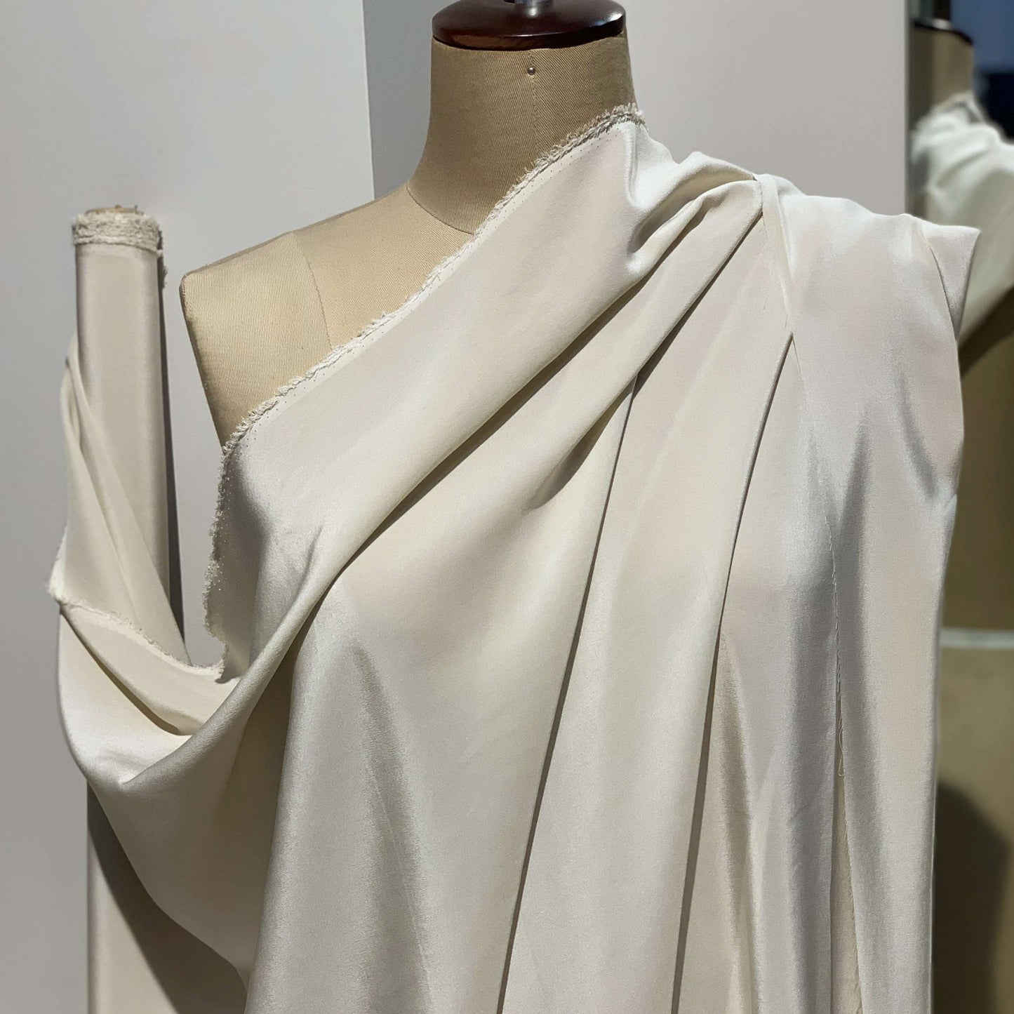 Crepe De Chine showing the draped almond color version of a Pure mulberry silk with fluid drape and a matte face and cool handle