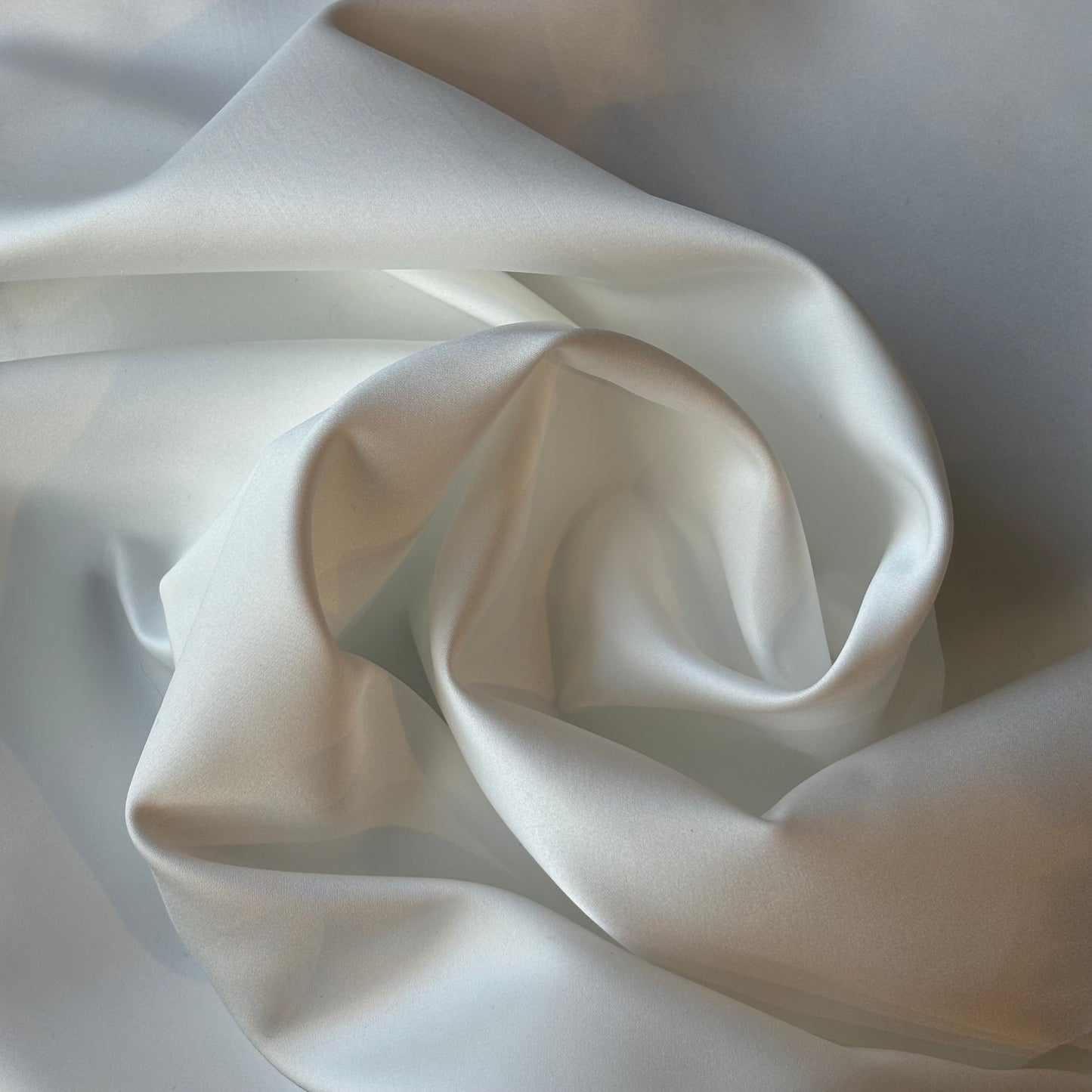 Displaying Double Satin an ivory colored double sided pure Polyester microfibre satin fabric