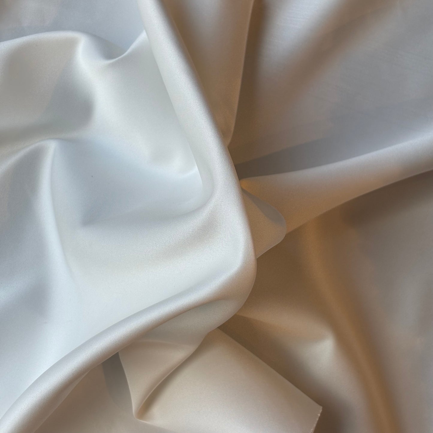 Displaying Double Satin an ivory colored double sided pure Polyester microfibre satin fabric