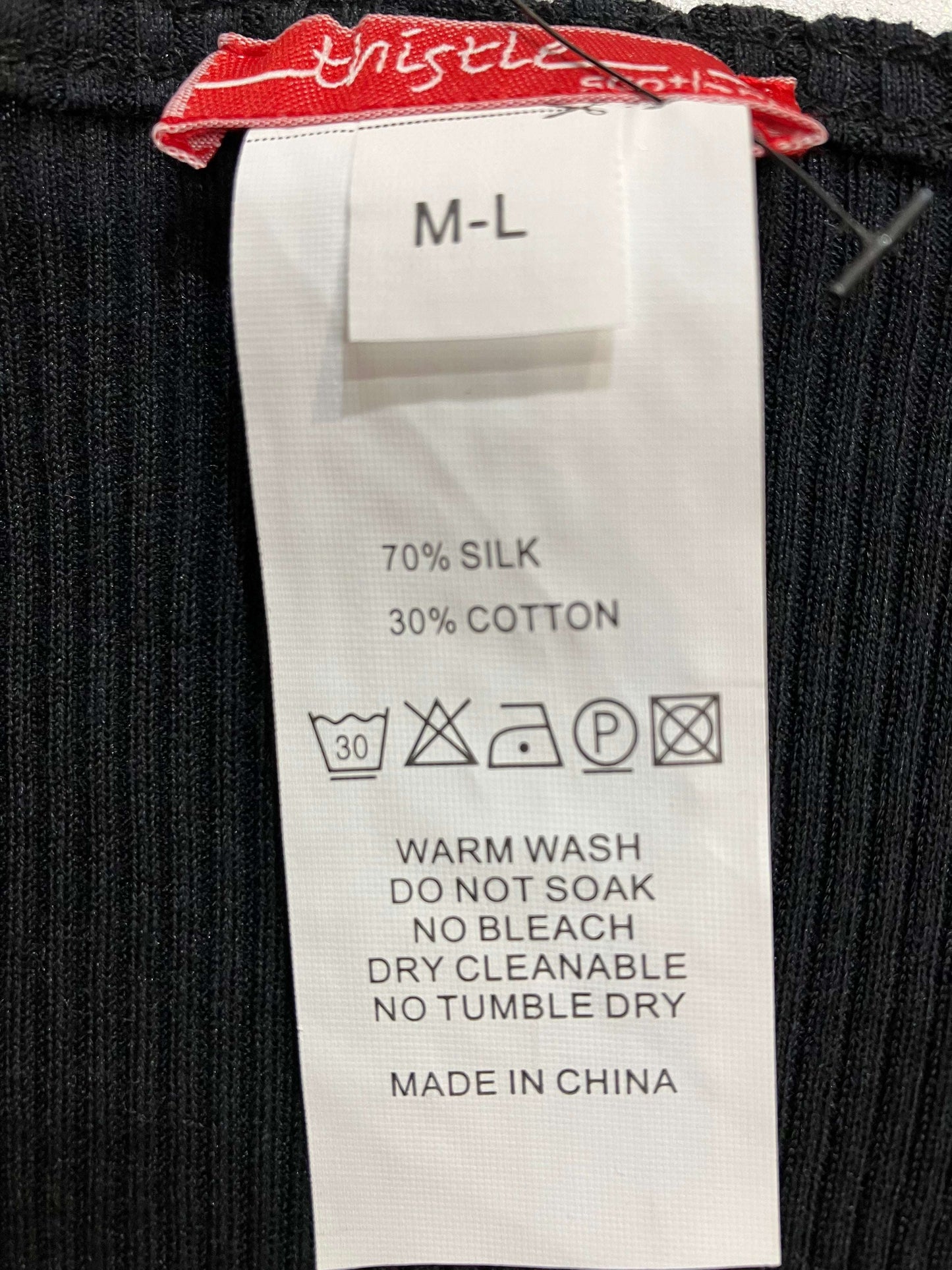 Presenting the label of a silk and cotton cotton rib knit top with cap sleeves