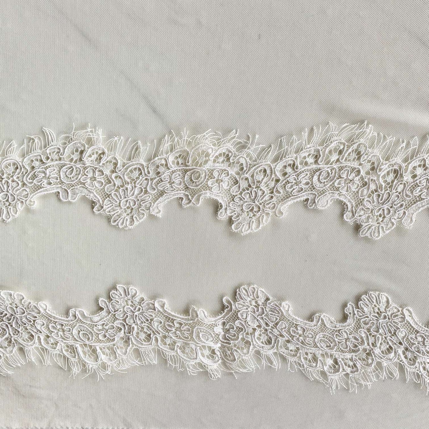 Presenting ingrid an ivory colored Scalloped rayon and nylon lace with corded embroidery and eyelash on trim