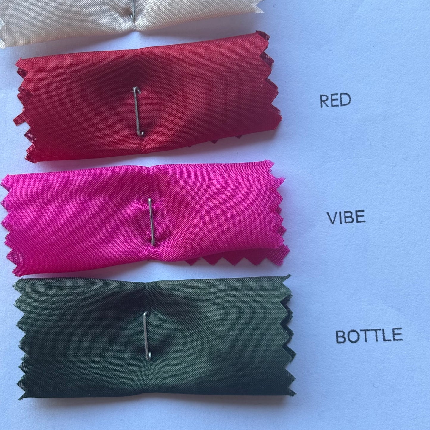 Presenting a selection of color card swatches red, vibe and bottle for Jap Silk