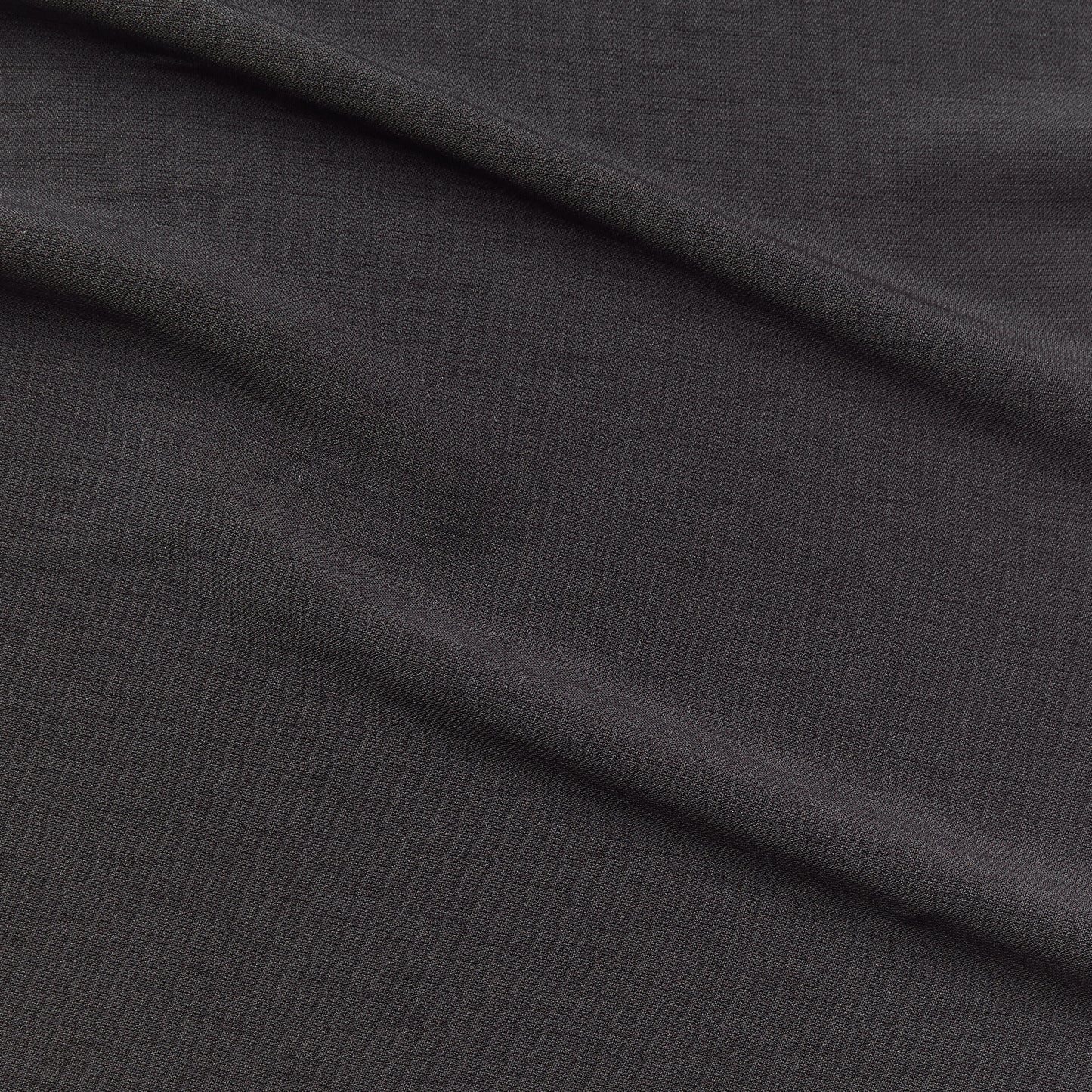 Ace displaying the Charcoal color version of a stretch smooth polyester and spandex blend with great drape