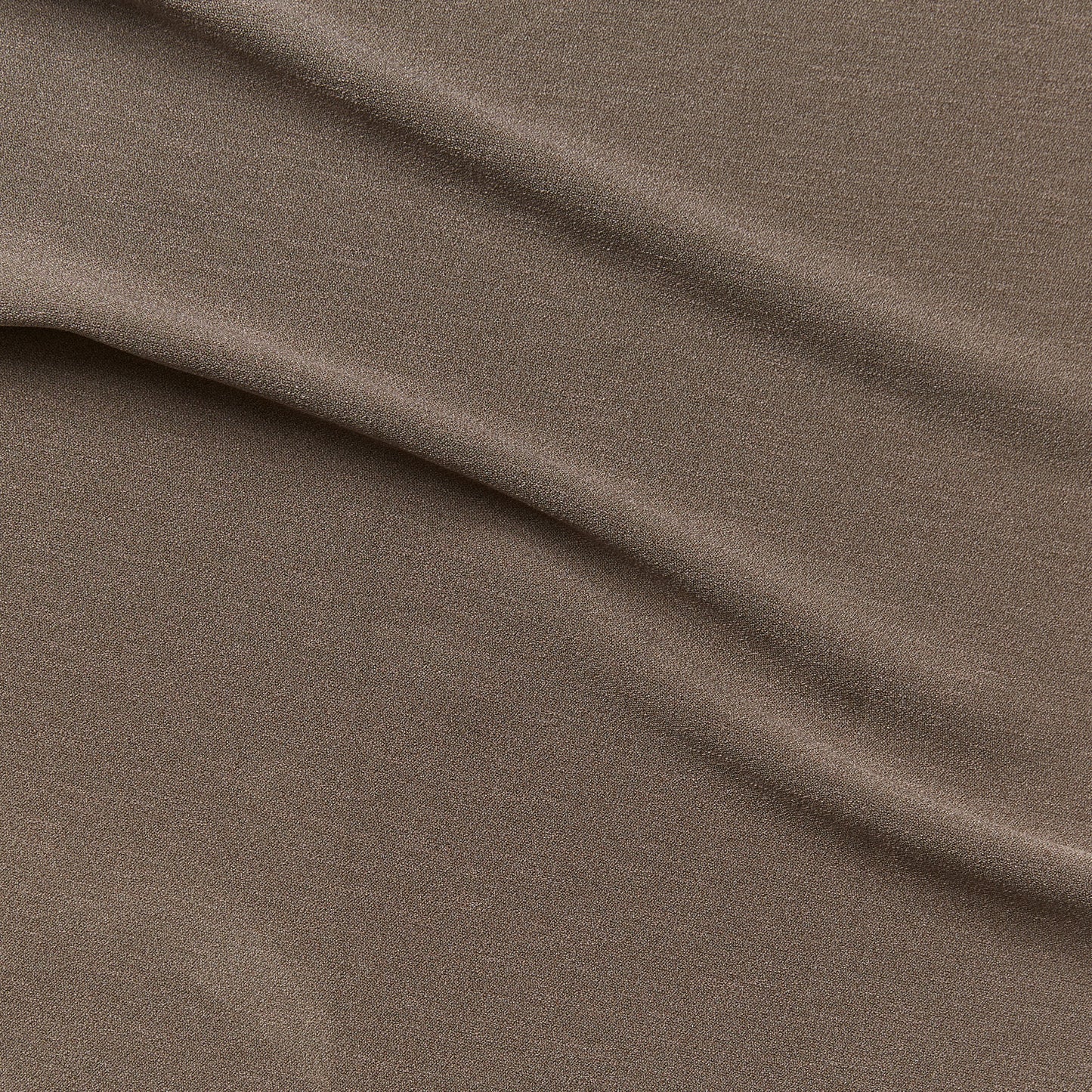 Ace displaying the taupe color version of a stretch smooth polyester and spandex blend with great drape