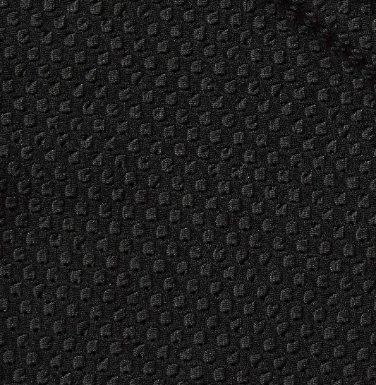 bigyarn presenting he black color version of a stretch jacquard with classic spots design on nylon and polyester with spandex closeup
