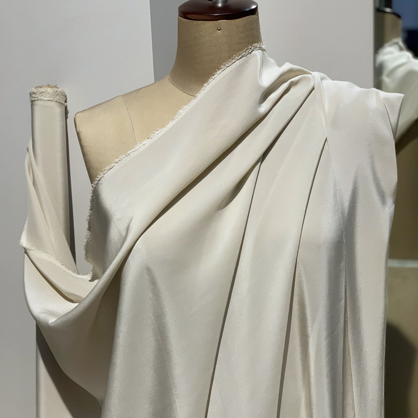 Crepe De Chine displaying the draped almond color version of a Pure mulberry silk with fluid drape and a matte face and cool handle