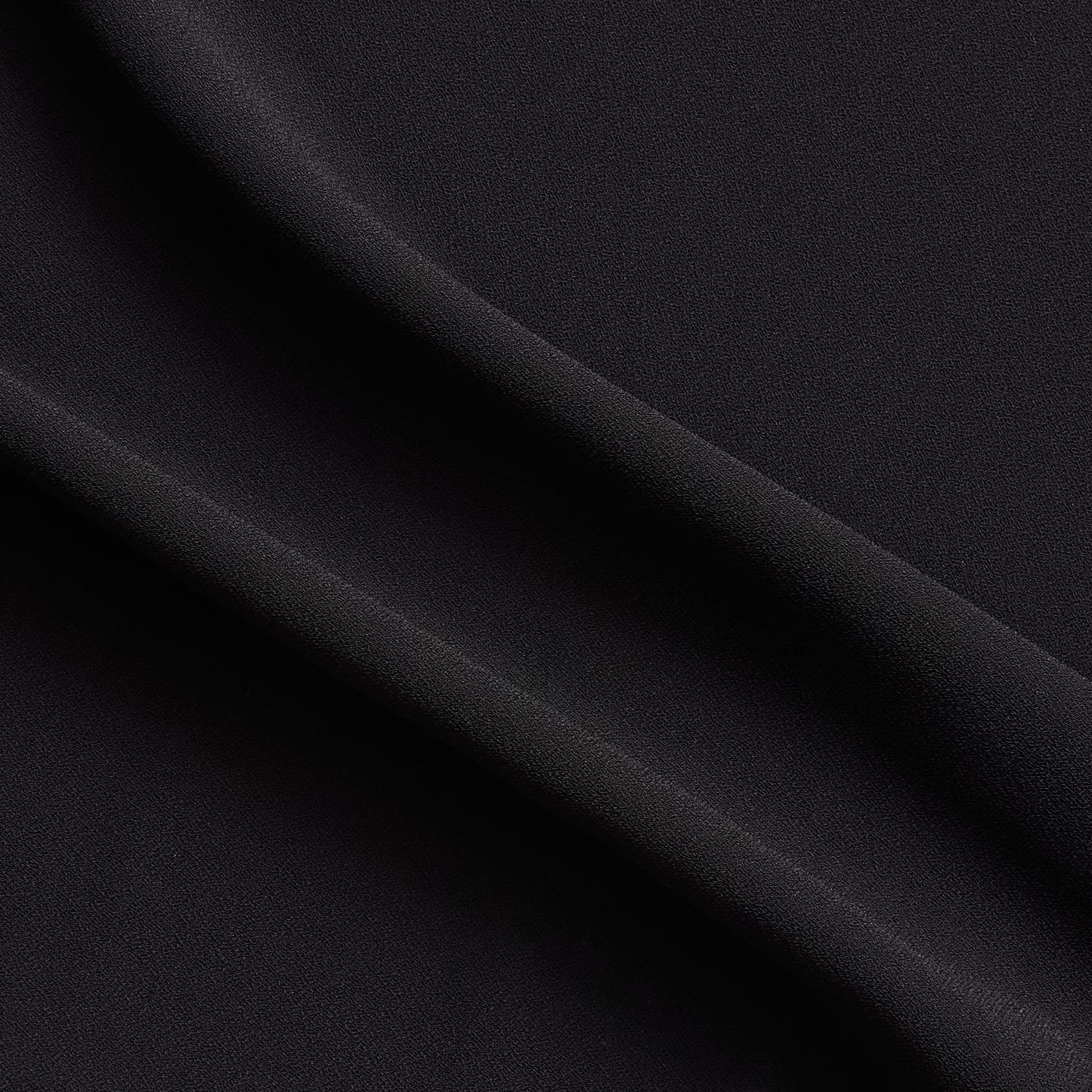 celebrity displaying the black colored version of a polyester microfiber satin back crepe with fluid drape