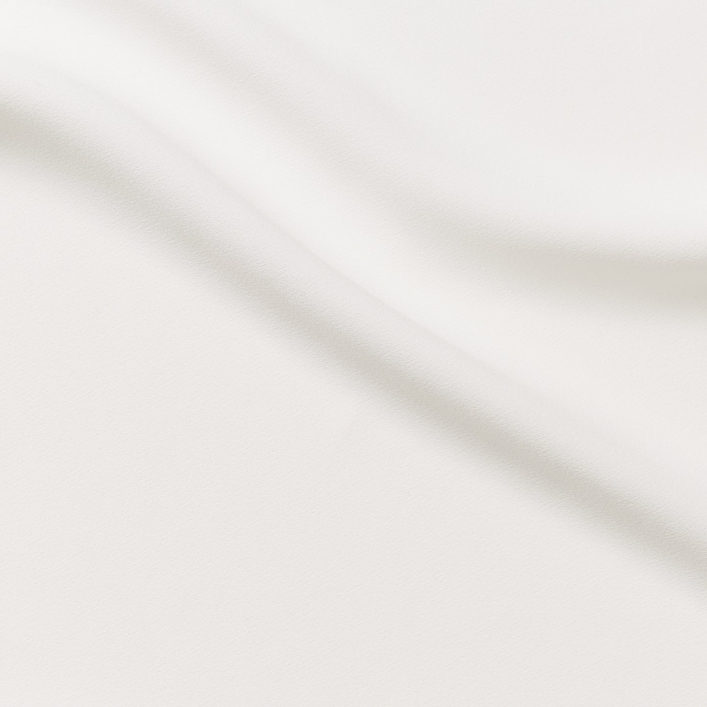 celebrity displaying the ivory colored version of a polyester microfiber featuring a double sided matte face & satin back crepe with fluid drape