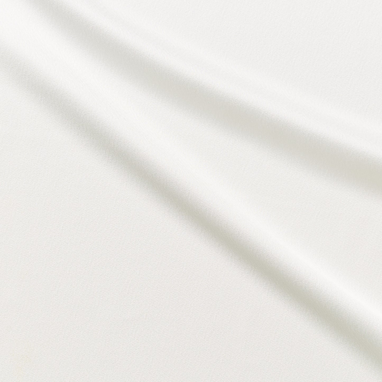 celebrity displaying the ivory colored version of a polyester microfiber featuring a double sided matte face & satin back crepe with fluid drape