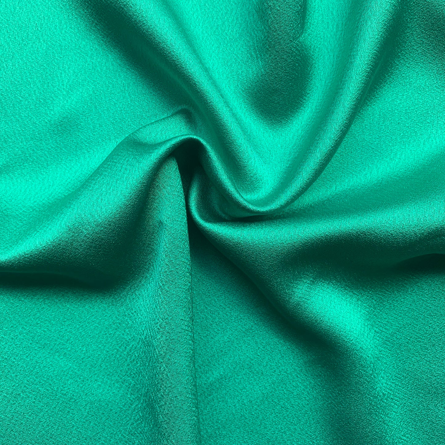 Celebrity displaying the the Kelly Color Version of a satin backed crepe polyester microfiber with fluid drape