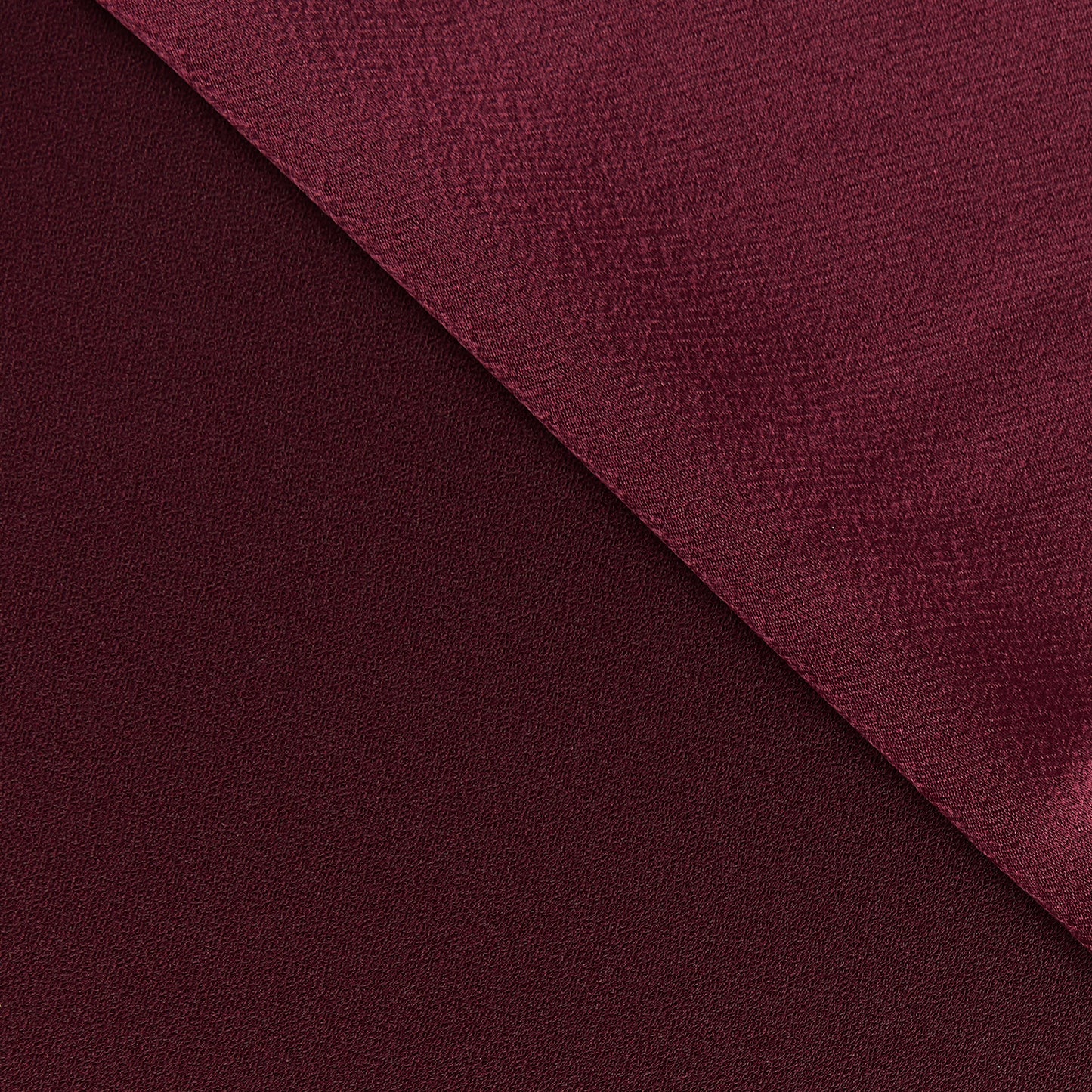 celebrity displaying the ruby colored version of a polyester microfiber both sides with fluid drape with fluid drape with both sides shown