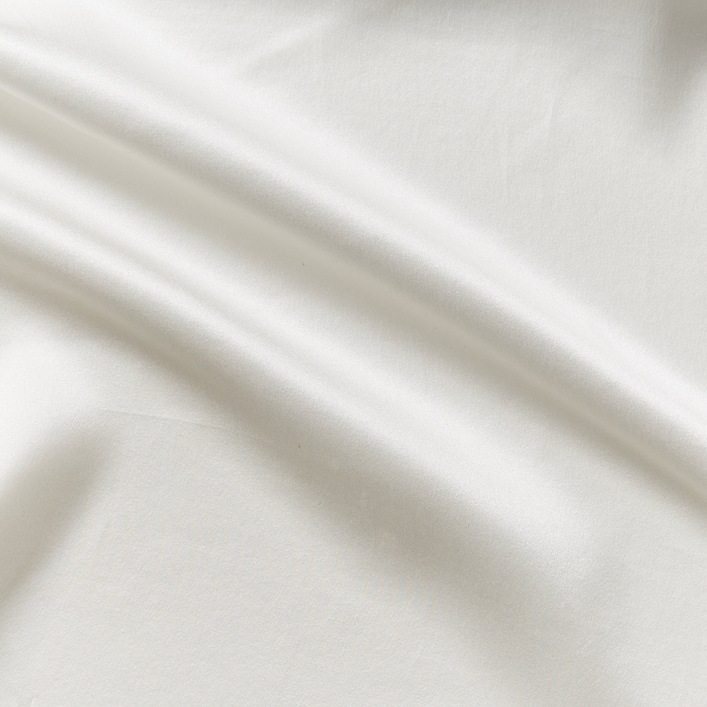 Displaying charmeuse a natural colored pure light weight silk with satin lustre and fluid drape featuring a wide width