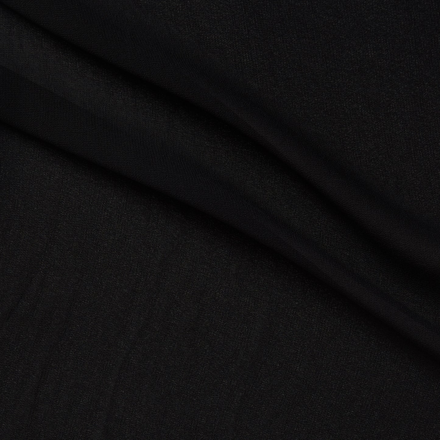Showing Chelsea a black colored double georgette pure viscose fabric with crinkled face and fluid drape