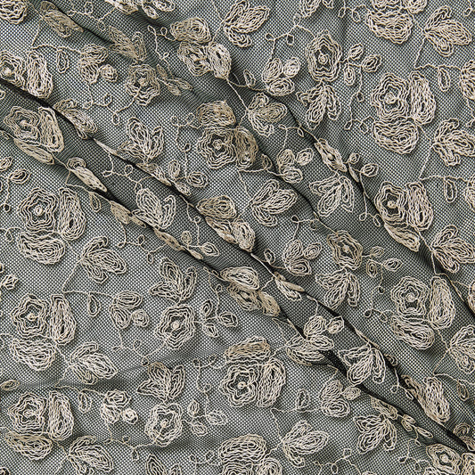 claudia presenting an ivory color version of a rayon Floral roses design embroidered on a black nylon mesh