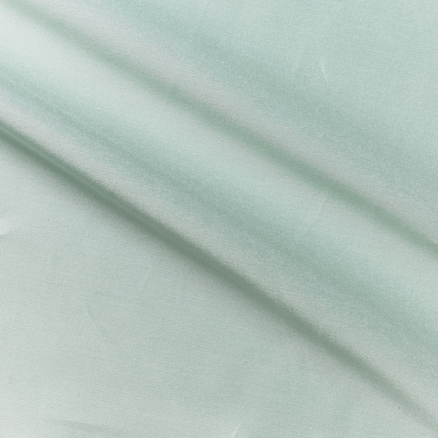 Corisia presenting the Mint color version of a soft silk viscose and cotton blend with natural silk sheen medium softness and moderate drape