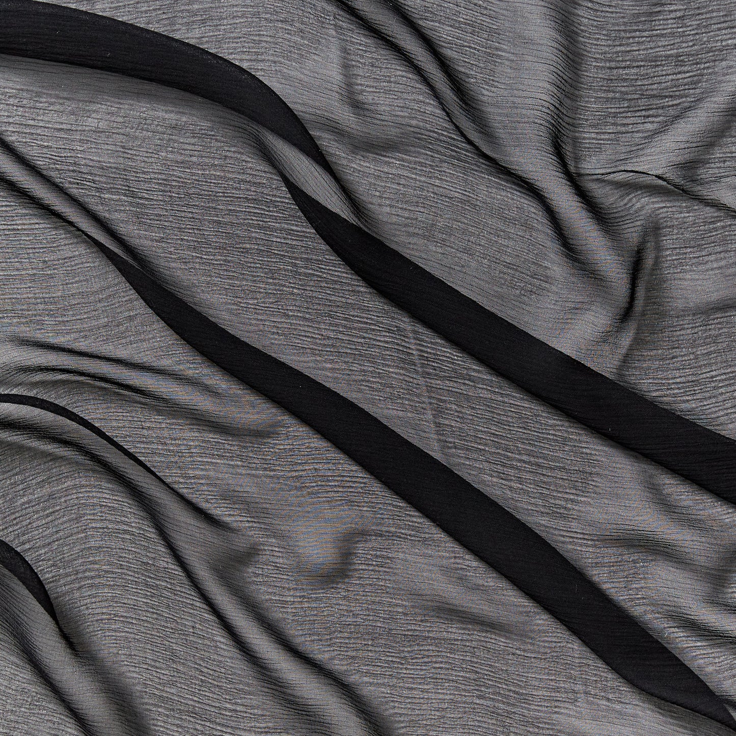 silk crinkle chiffon presenting the black color version of a sheer soft pure silk with textured yoryu weave and fluid drape