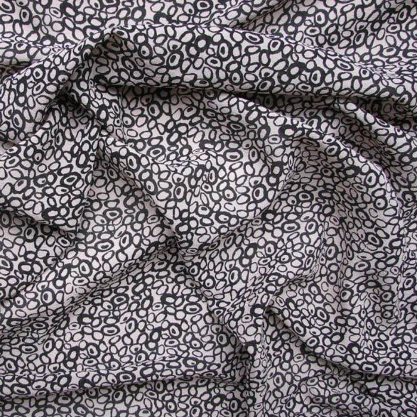 Displaying Hoops a Black colored fabric with a timeless Abstract black and white print on heavy Pure Silk georgette