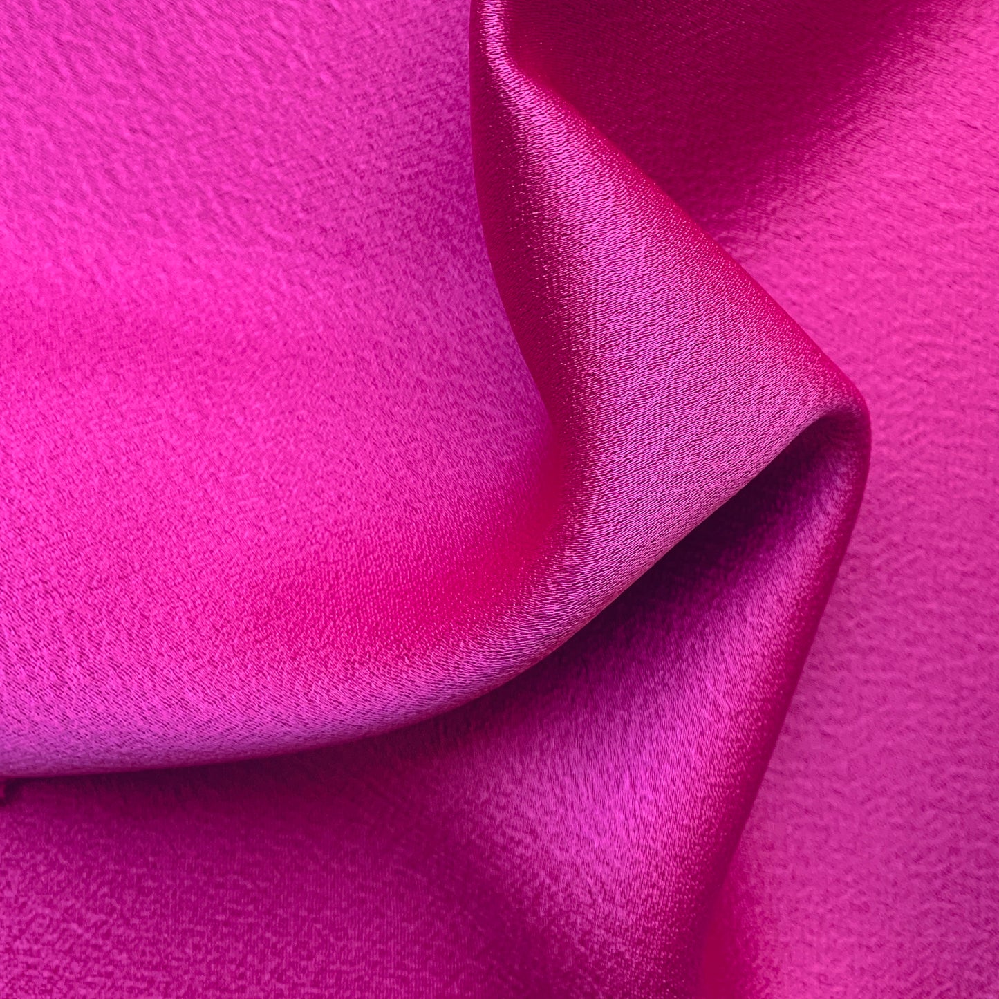 Celebrity displaying the the fuchsia Color Version of a satin backed crepe polyester microfiber with fluid drape