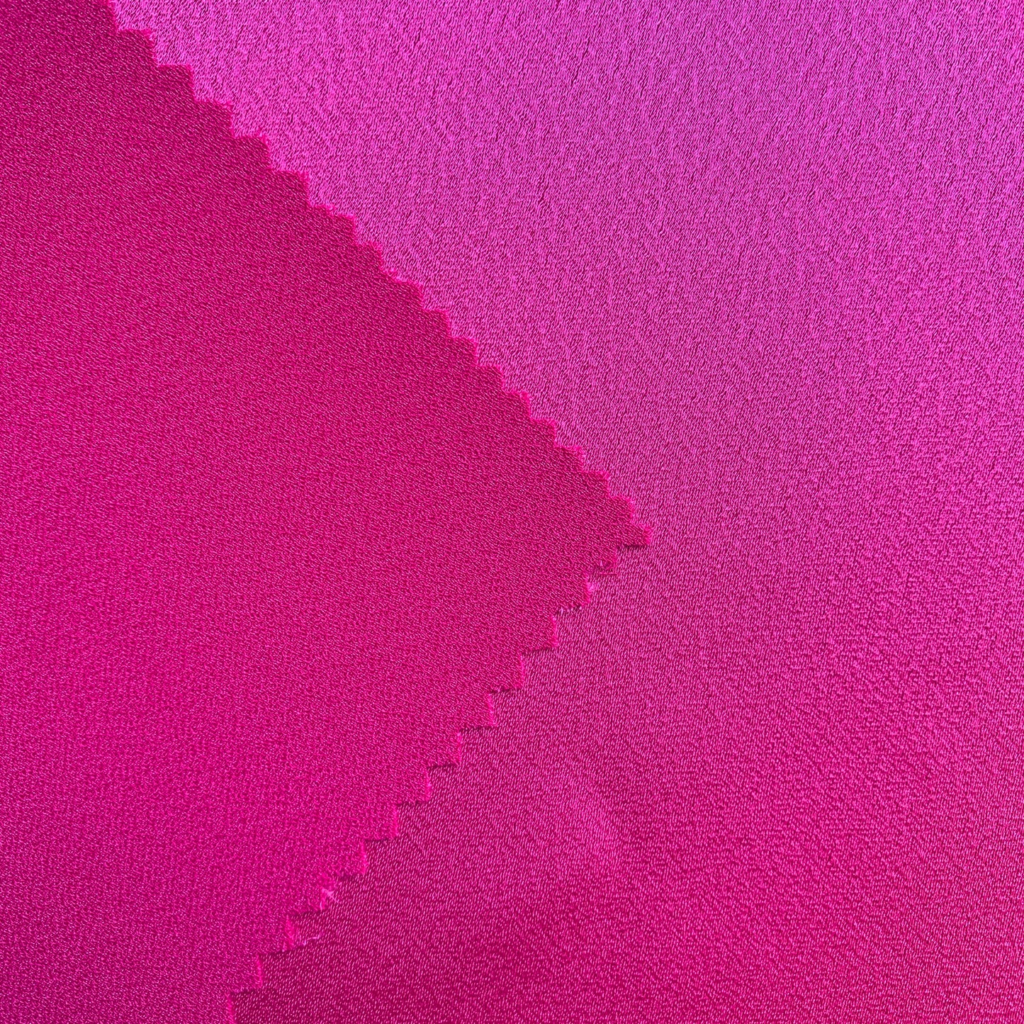 Celebrity displaying the fuchsia Color Version of a satin backed crepe polyester microfiber with fluid drape