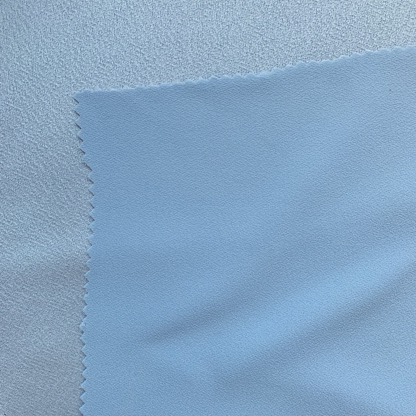 Celebrity displaying the Blue Color Version of a satin backed crepe polyester microfiber with fluid drape