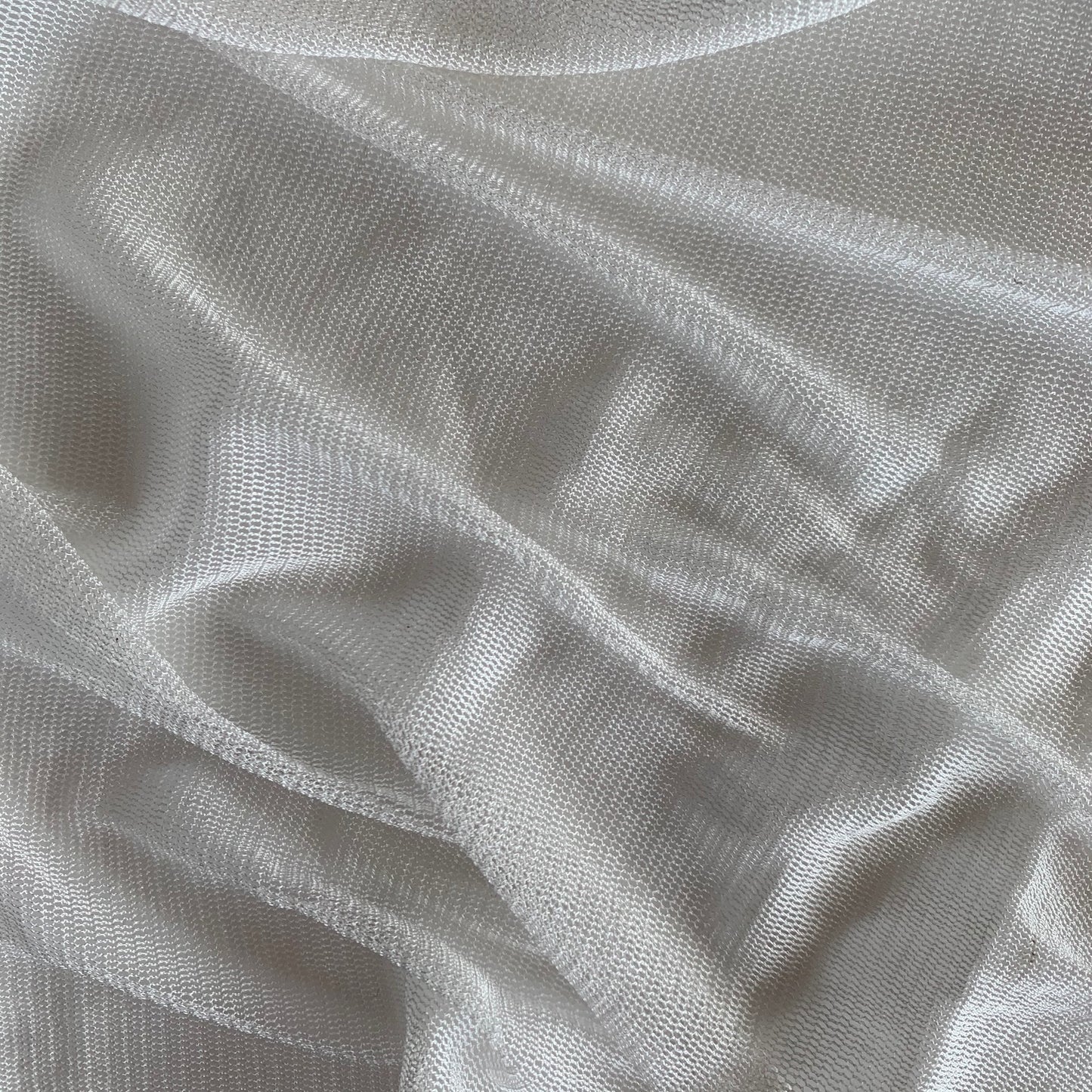 vapour presenting the natural color variant of a soft sheer breathable light weight matte pure silk tulle with natural silk sheen