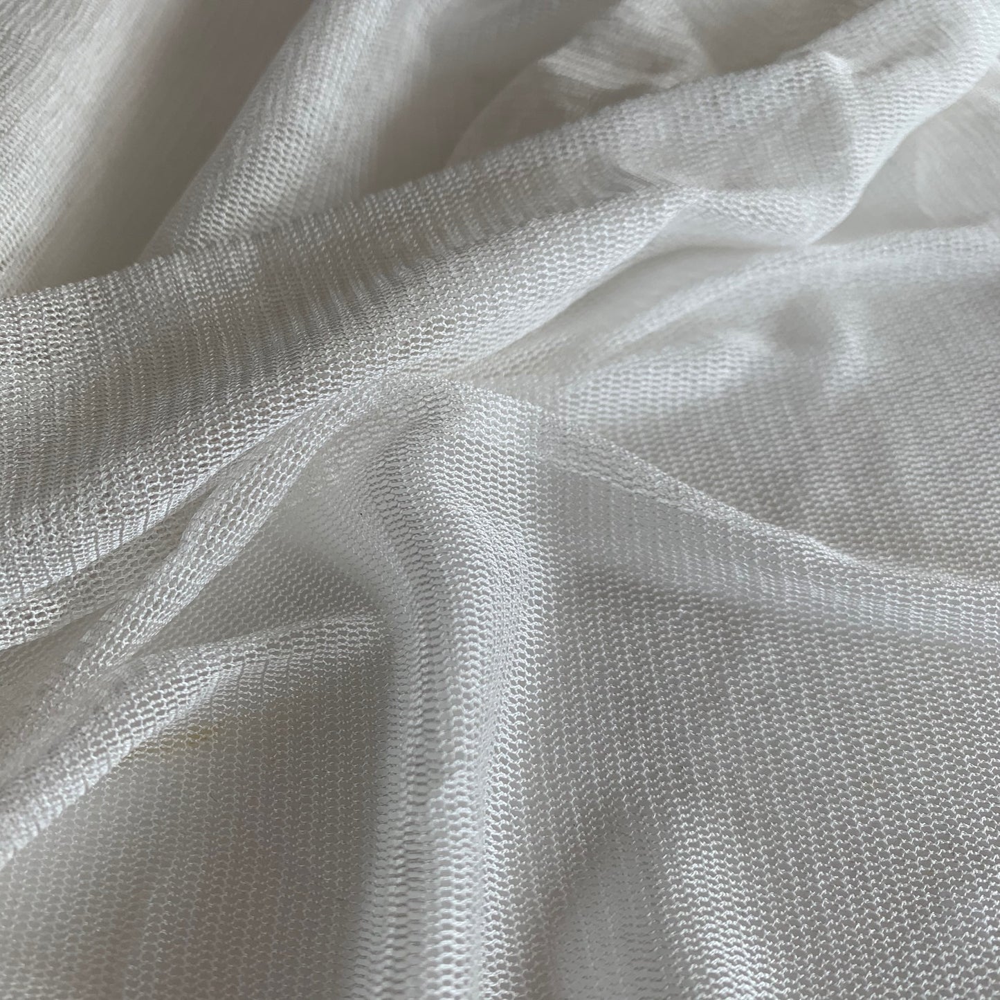 vapour presenting the natural color variant of a soft sheer breathable light weight matte pure silk tulle with natural silk sheen