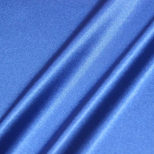 lola displaying the royal color version of a stretch light weight soft satin polyester with spandex