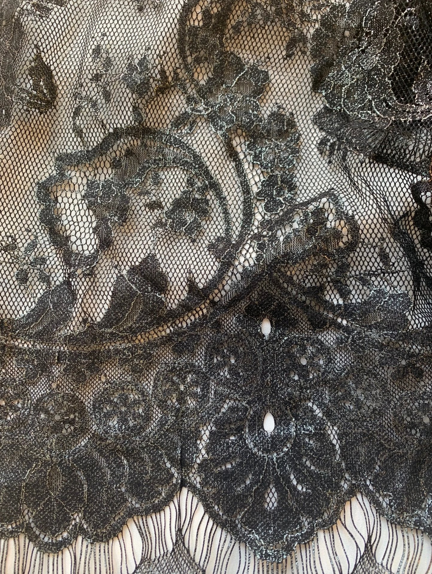 Presenting tivoli which features a metallic black EYELASH on a nylon, rayon and cotton blend with metallic print