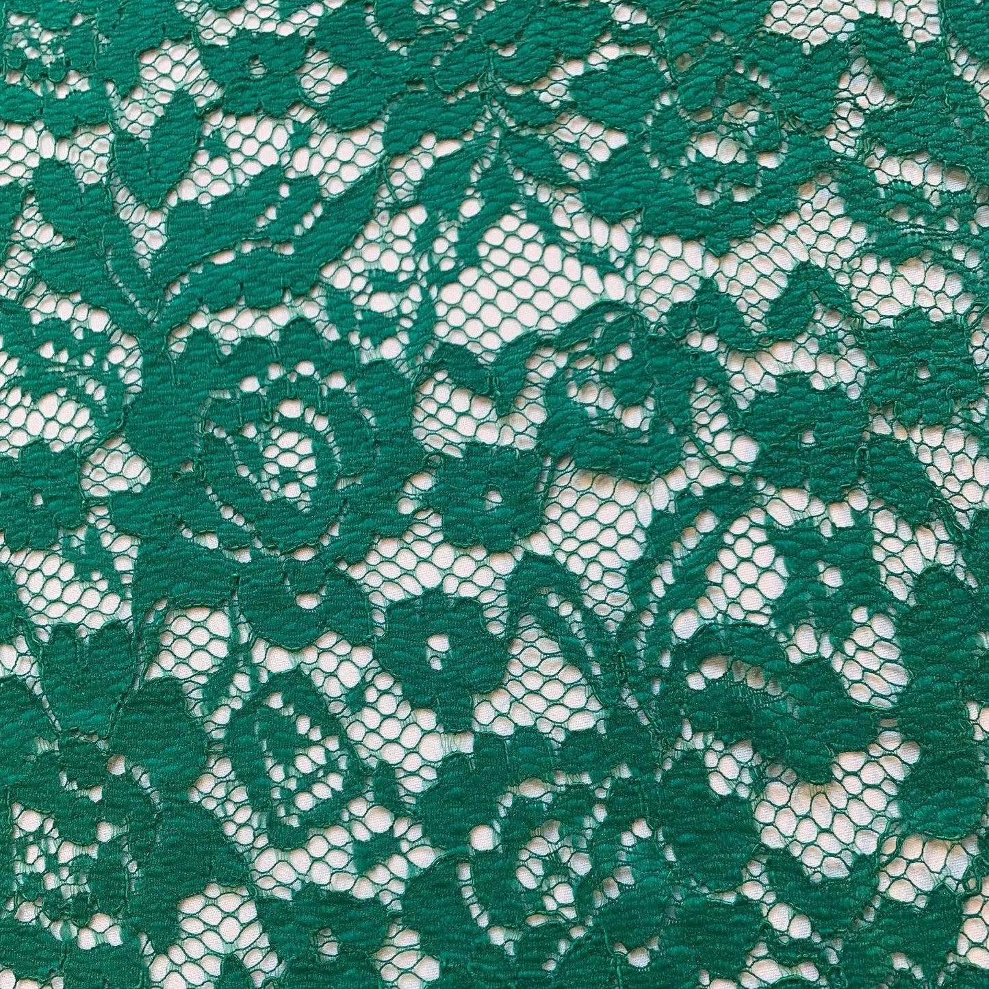 mayfair presenting the emerald color version of a rayon and nylon classic rochelle lace with rose design and double scalloped edge
