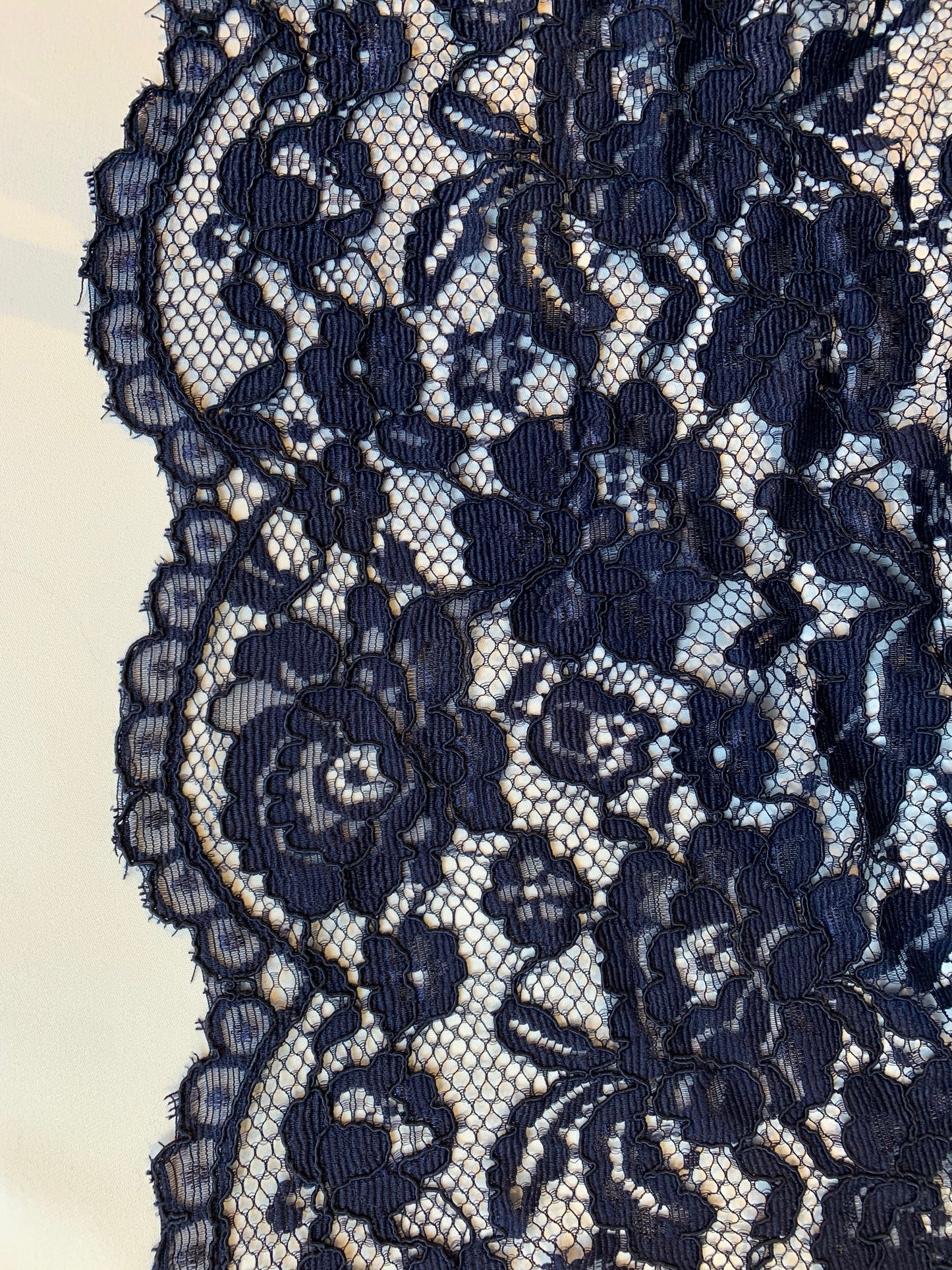 mayfair presenting a double scalloped edge in the indigo color version of a rayon and nylon classic rochelle lace double scalloped edge