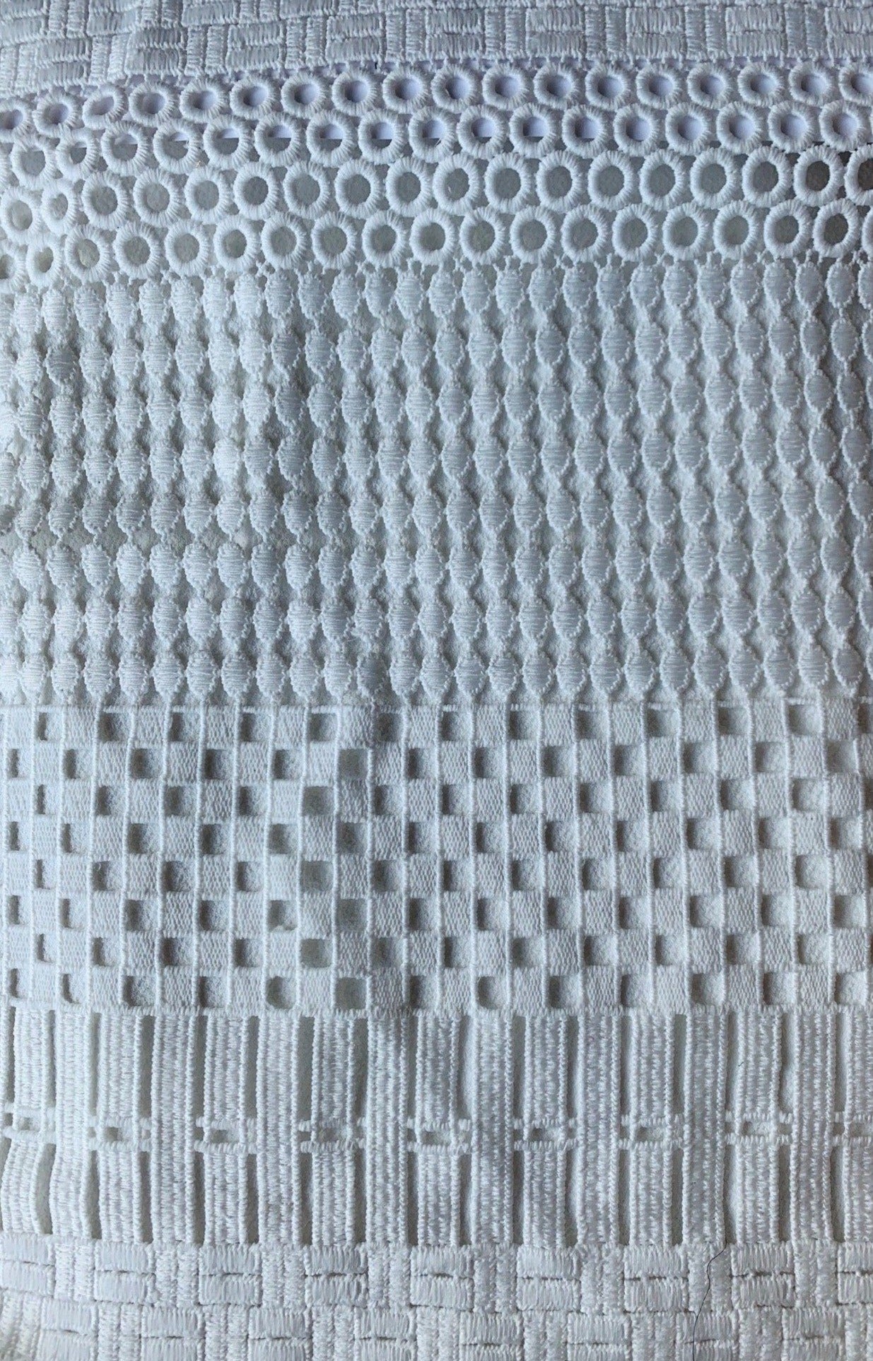 Exhibiting lido an ivory colored pure polyester paneled geometric design mid weight Guipure lace