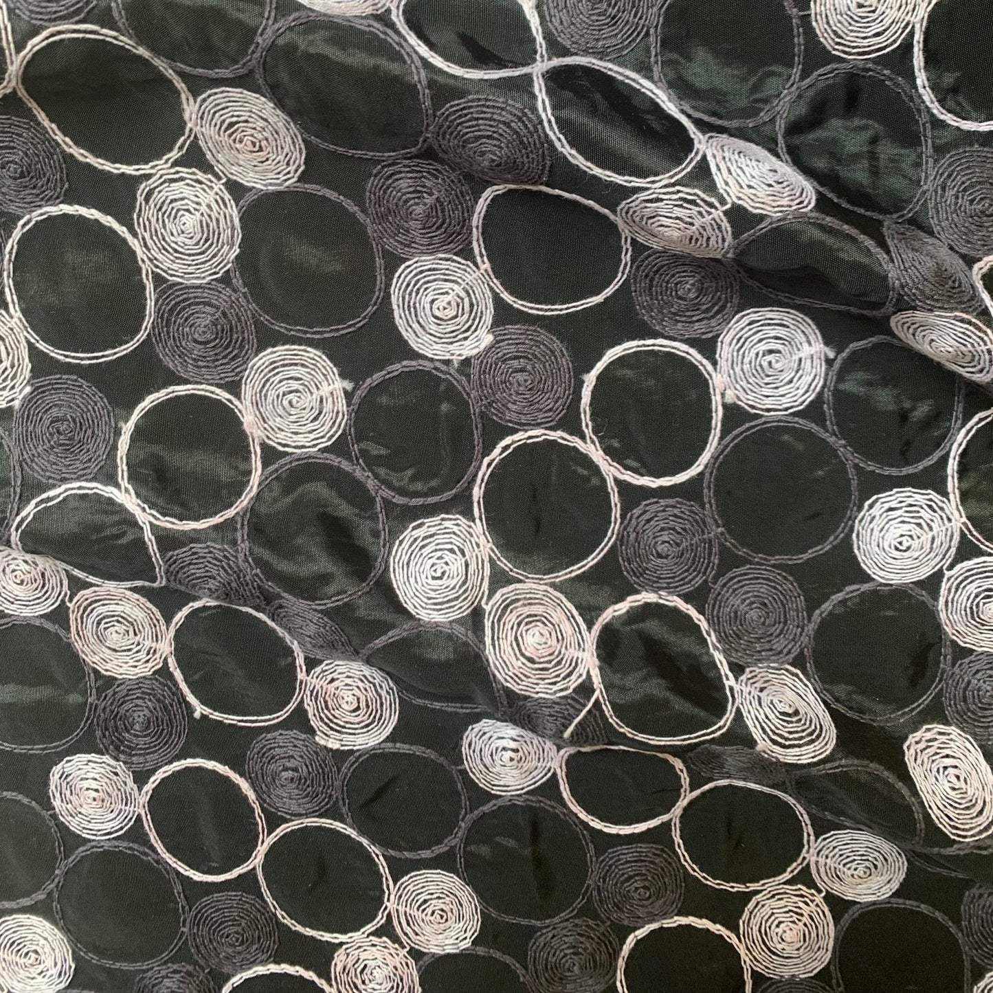 Presenting shabby featuring black colored geometric Circle embroidery on polyester and nylon taffeta with cool and crisp hand feel