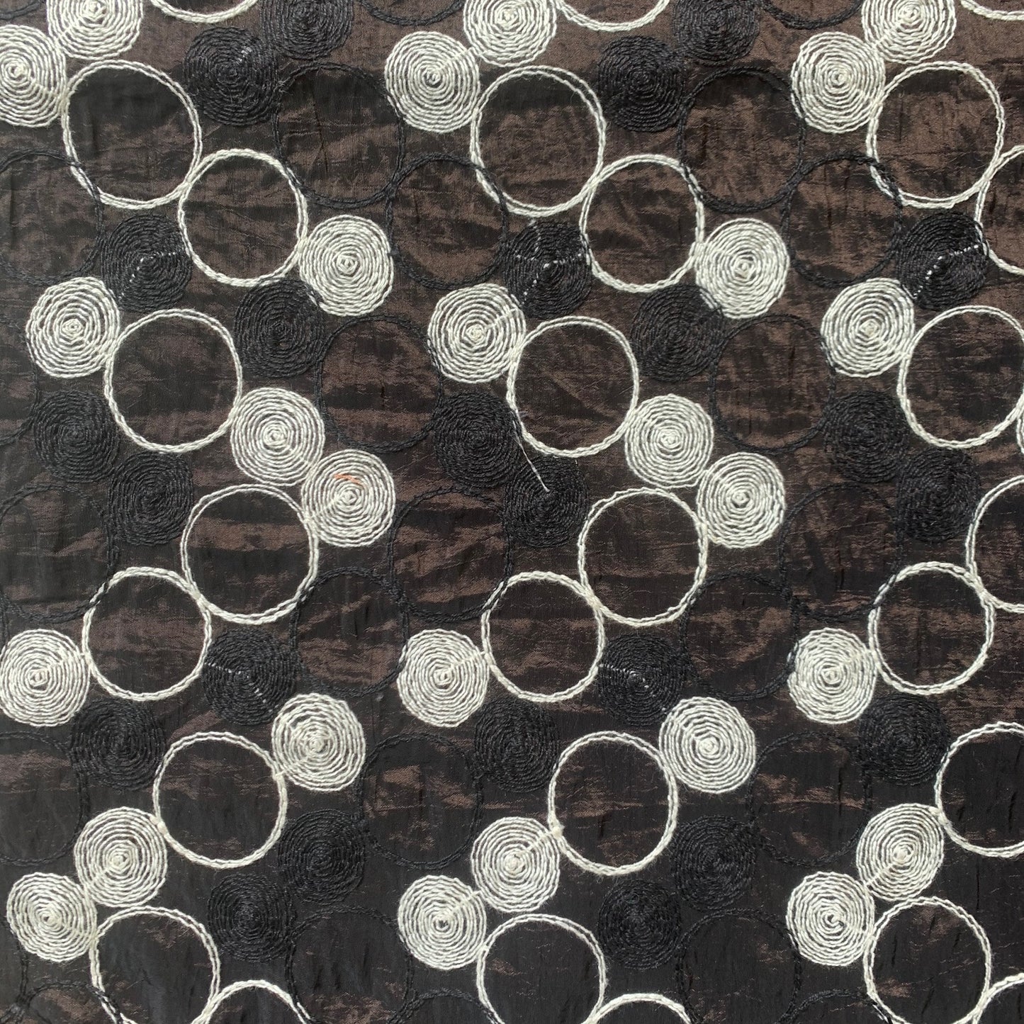 Presenting shabby featuring black colored geometric Circle embroidery on polyester and nylon taffeta with cool and crisp hand feel