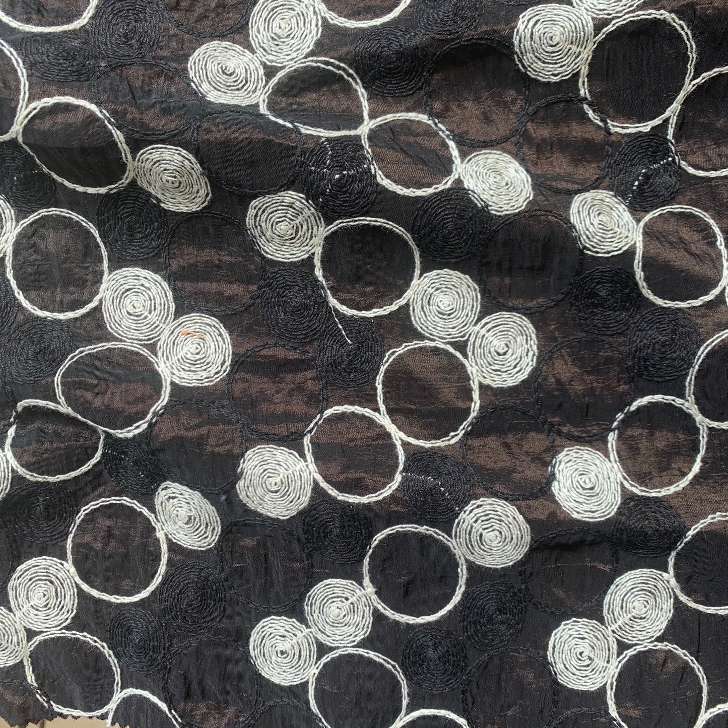 Presenting shabby featuring black colored geometric Circle embroidery on polyester and nylon taffeta with cool and crisp hand feel