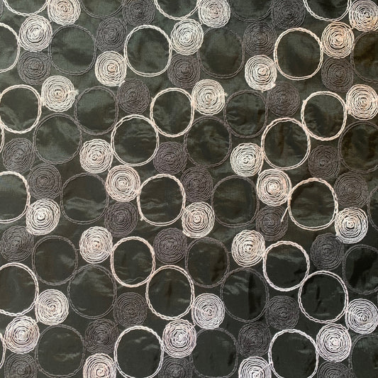 Showing shabby featuring black colored geometric Circle embroidery on polyester and nylon taffeta with cool and crisp hand feel