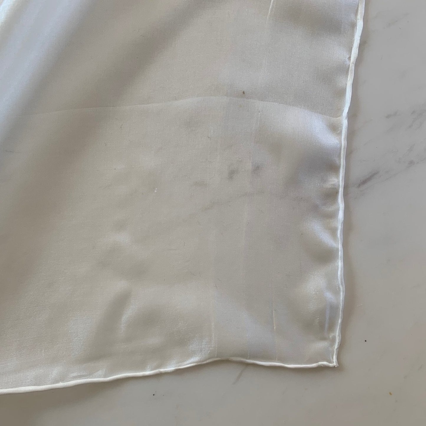 Presenting the JAP SILK scarf in natural color featuring a soft light weight pure silk scarf 28x160cm with fluid drape corner shown
