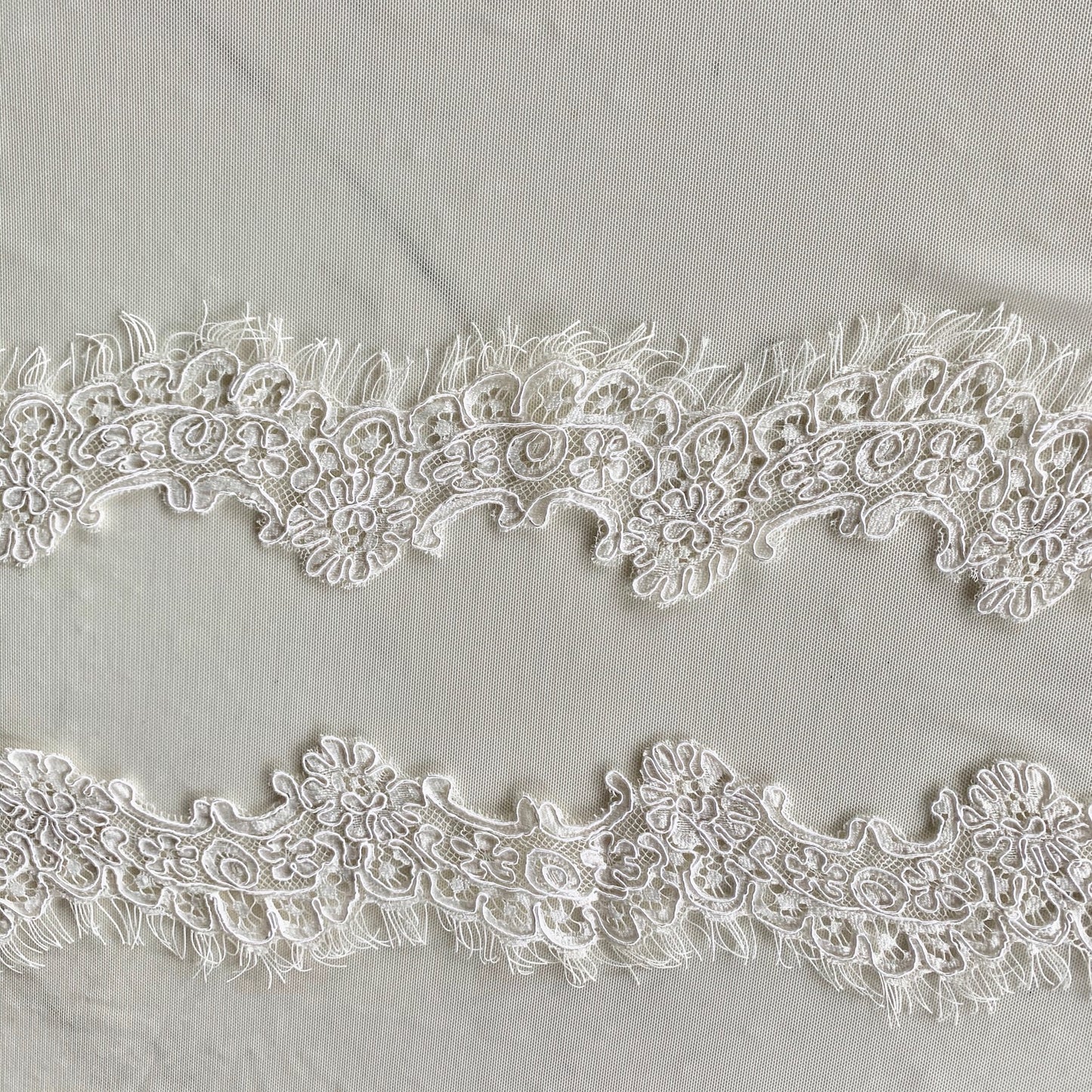 Featuring ingrid an ivory colored Scalloped rayon and nylon lace with corded embroidery and eyelash on trim