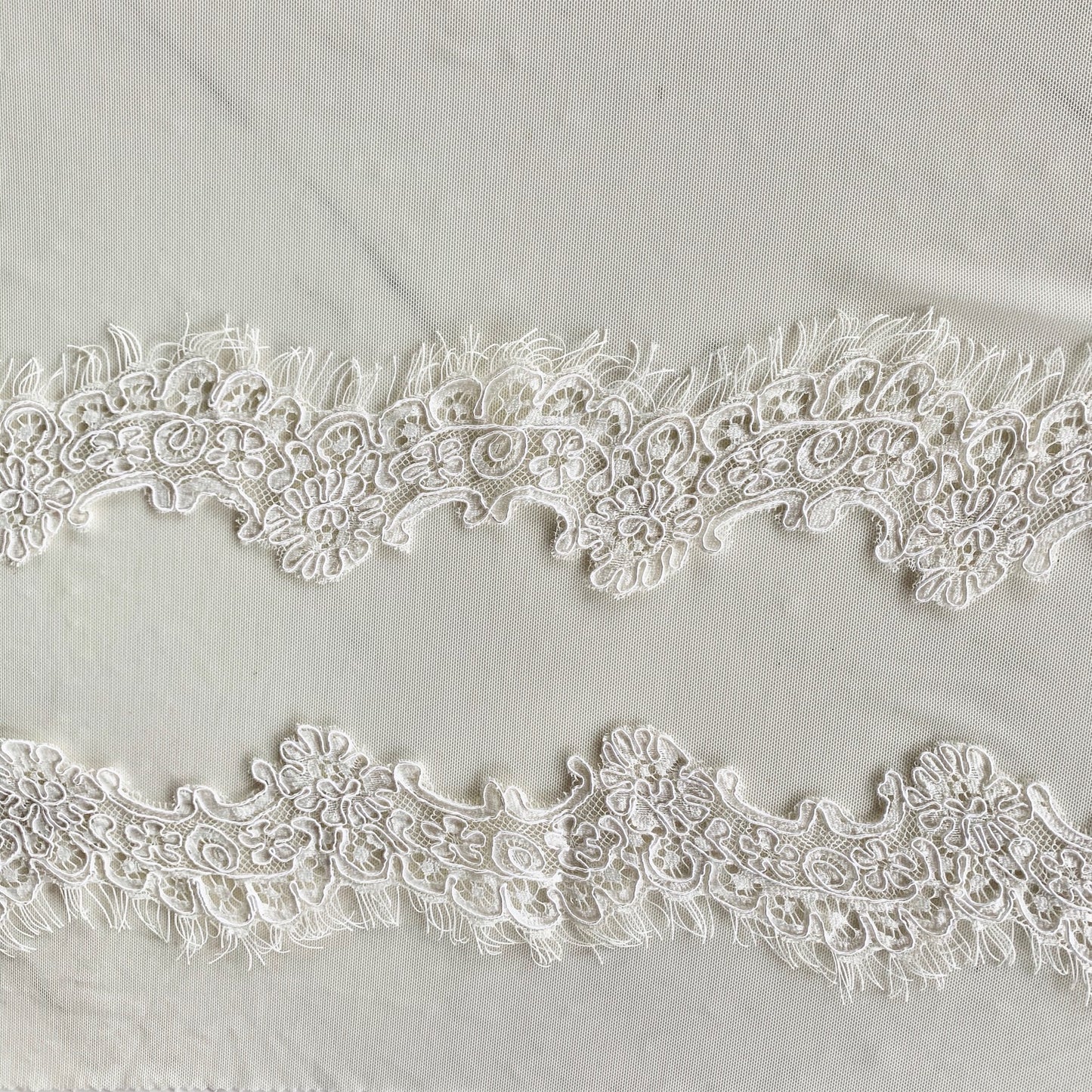 Featuring ingrid an ivory colored Scalloped rayon and nylon lace with corded embroidery and eyelash on trim
