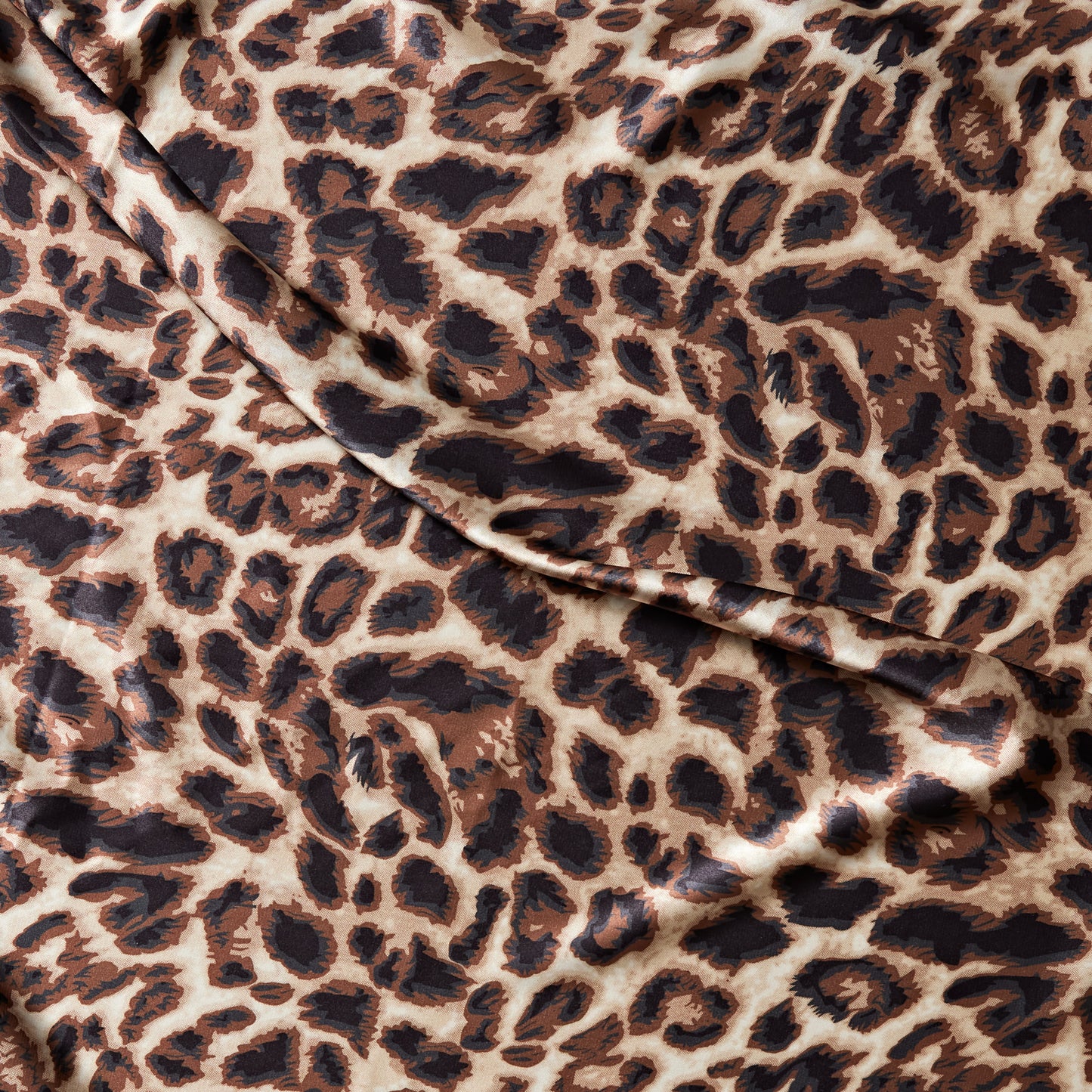 lola presenting the animal print version of a stretch light weight soft satin polyester with spandex