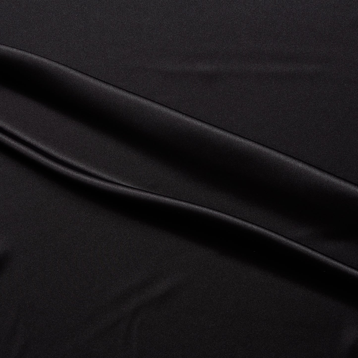 lola presenting the black color version of a stretch light weight soft satin polyester with spandex