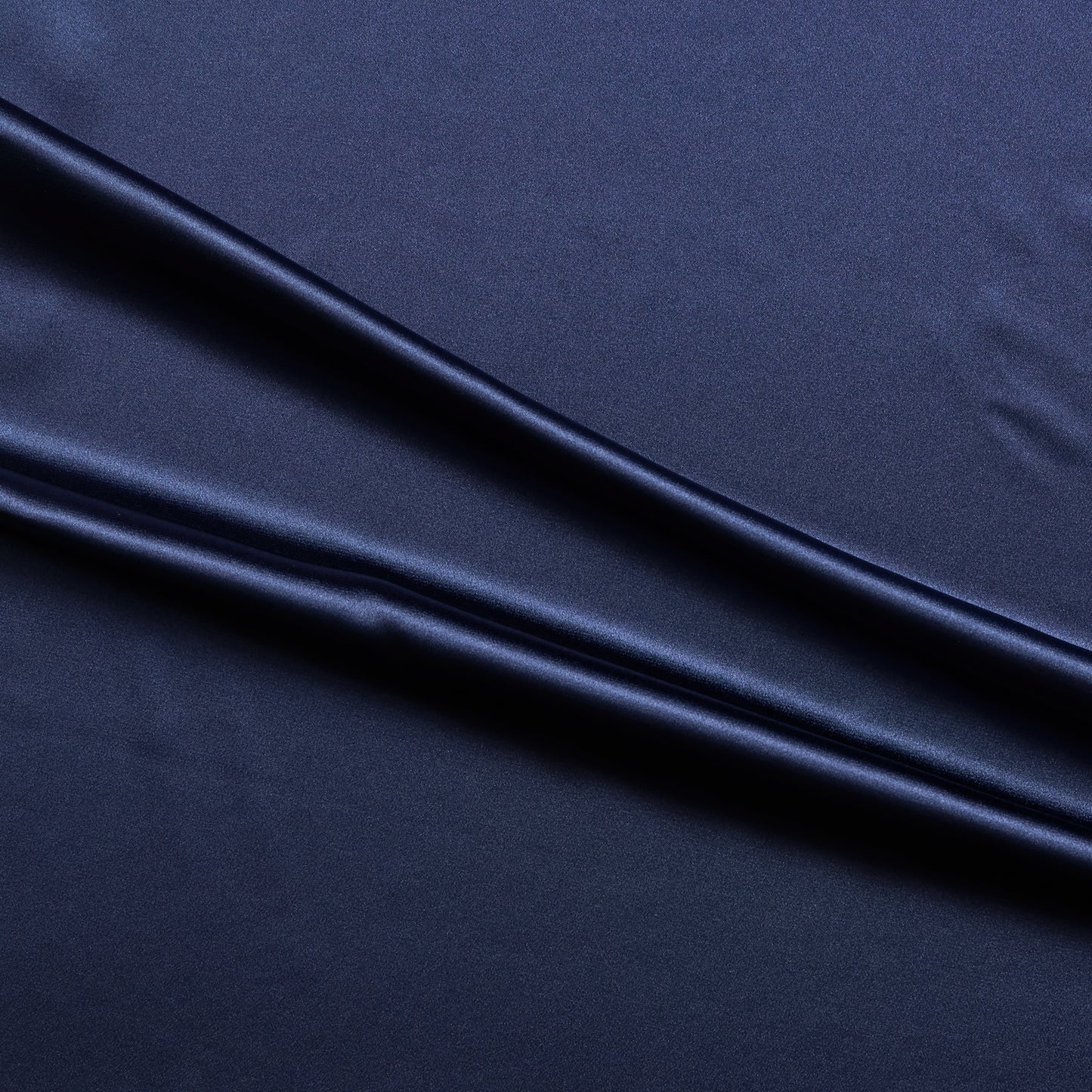 lola presenting the navy color version of a stretch light weight soft satin polyester with spandex