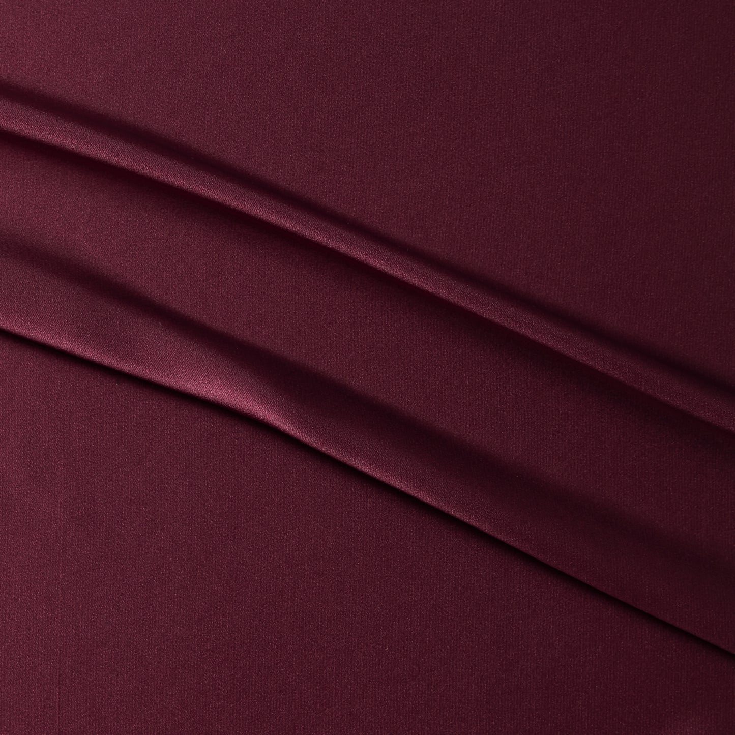 lola presenting the ruby color version of a stretch light weight soft satin polyester with spandex