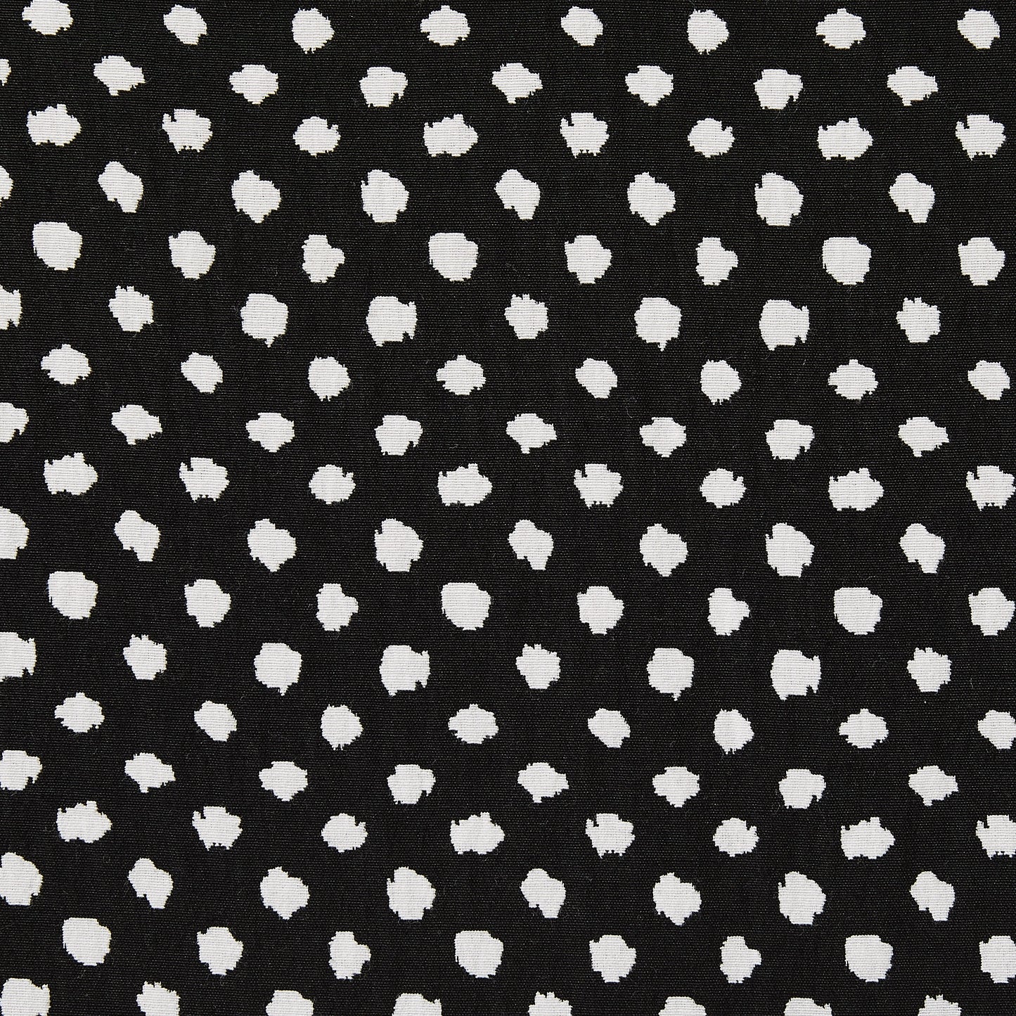 meteor presenting a black and white stretch, reversible, cotton poly with spandex blend featuring a dobby weave with whiite and black spotty blotches closeup