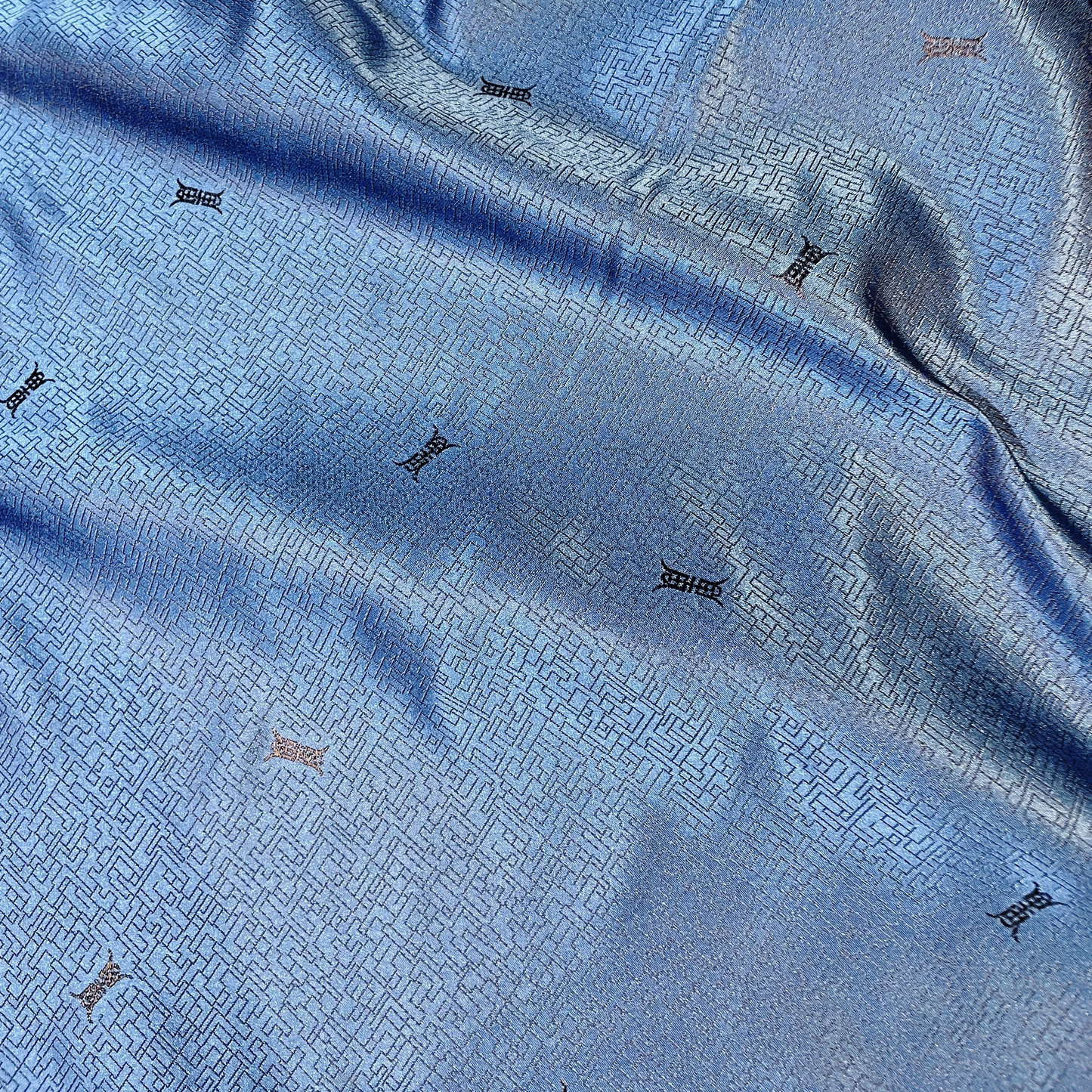 ming presenting the blue color version of a silk and rayon blend featuring a Chinese inspired jacquard print featuring good drape