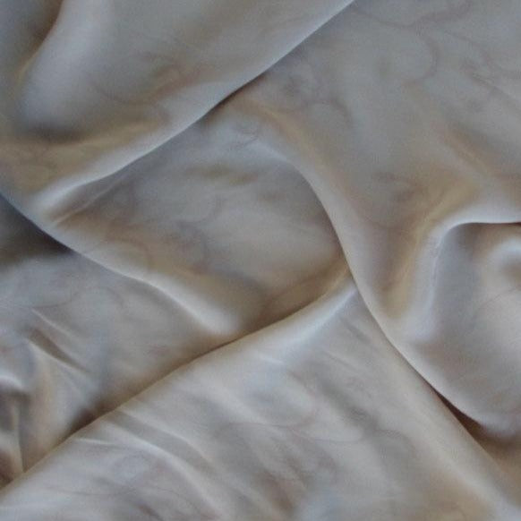 myth presenting the beige color version of a light weight floral jacquard pure rayon georgette with good drape