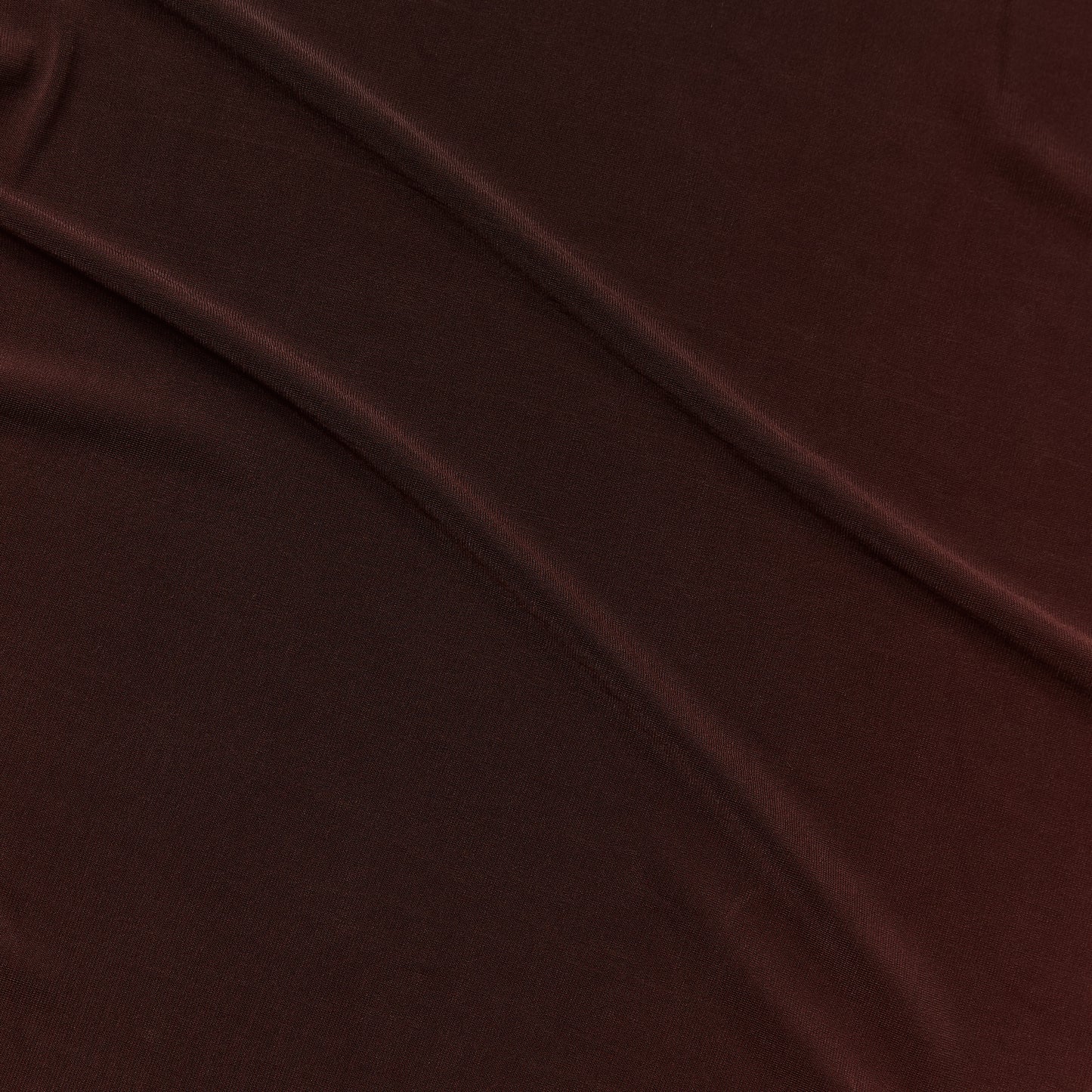 Exhibiting optima a chocolate colored slinky and soft stretch acetate blend with fluid drape