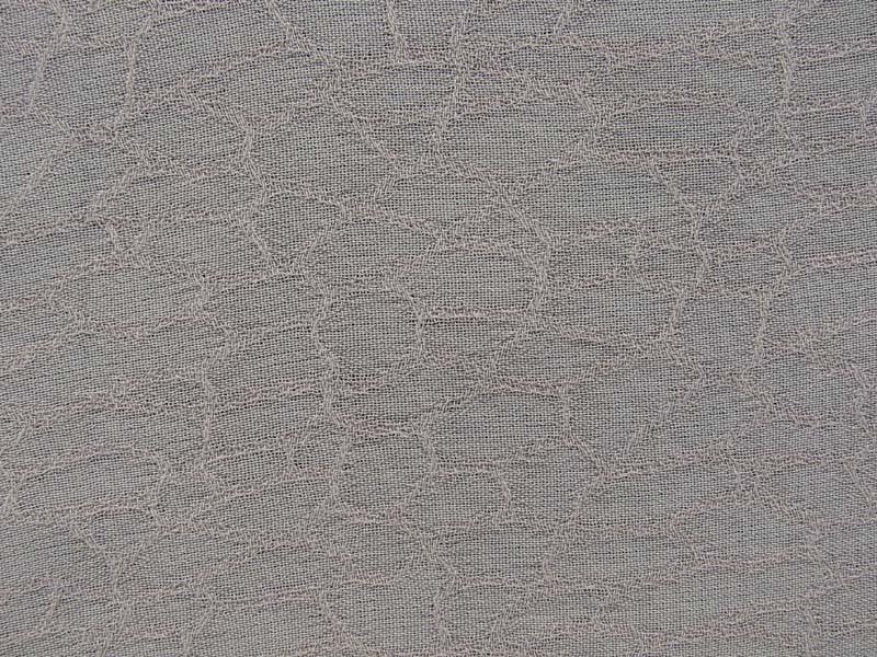 mythical exhibiting the beige color version of a fish scale jacquard light weight pure rayon with good drape