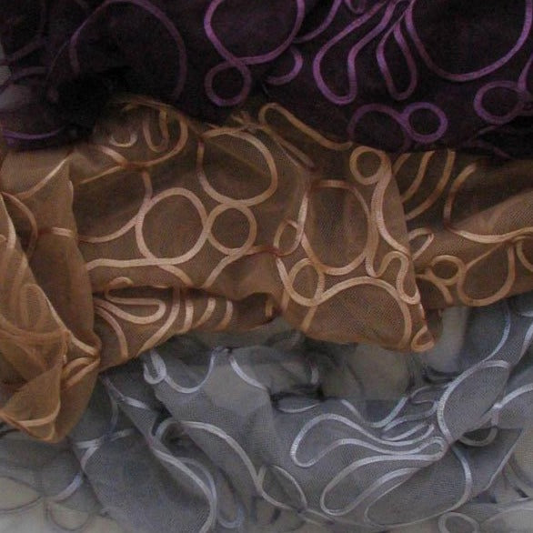 Showing the Roulette Polyester Net Rayon Tape Roulette Swatch showing plum tan and silver color variants