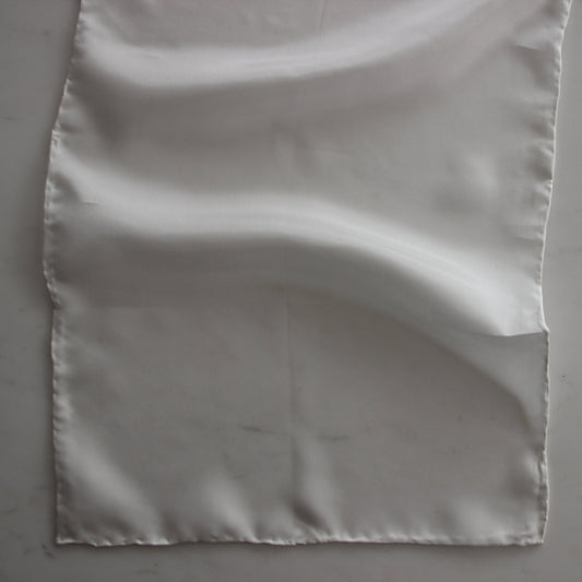 Displaying the JAP SILK scarf in natural color featuring a soft light weight pure silk scarf 28x160cm with fluid drape