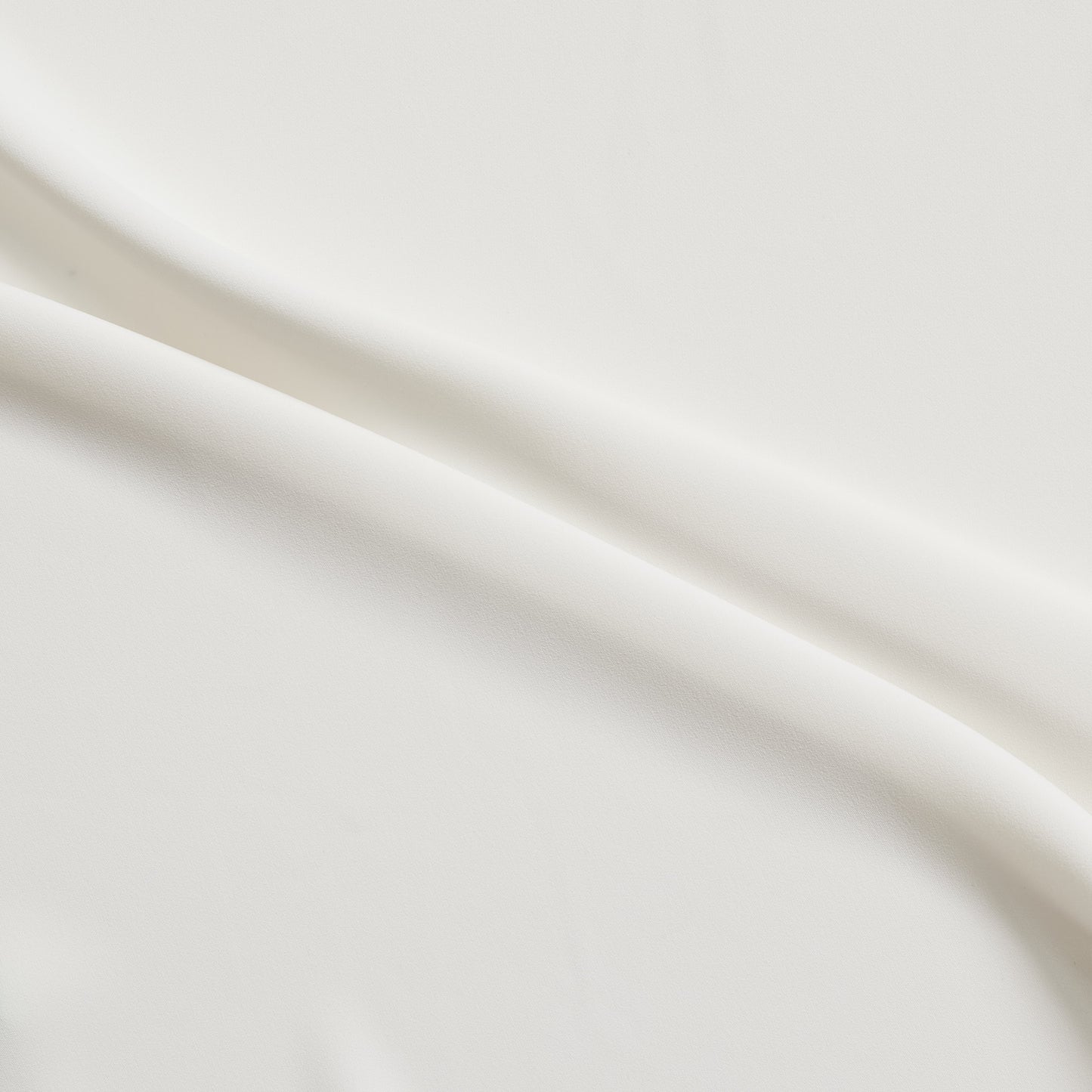 sensation presenting the ivory color version of a medium weight silk faille-like pure polyester with weft natural stretch and fluid drape